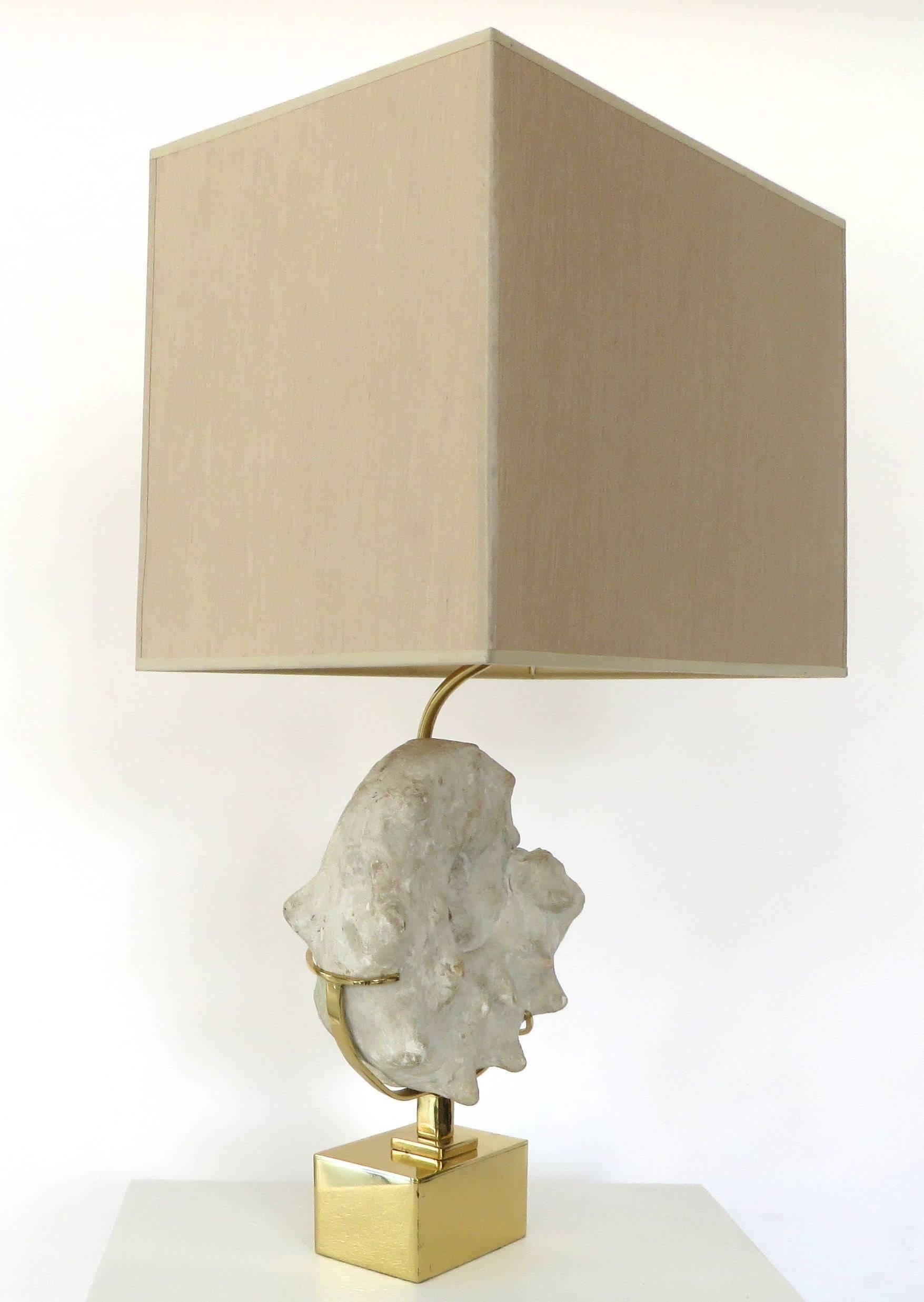 A 1970's, in the style of Willy Daro mounted Ammonite specimen lamp with taupe silk shade on brass base. Ammonites are an extinct group of marine invertebrate animals in the subclass Ammonoidea of the class Cephalopoda. 
Overall dimensions with
