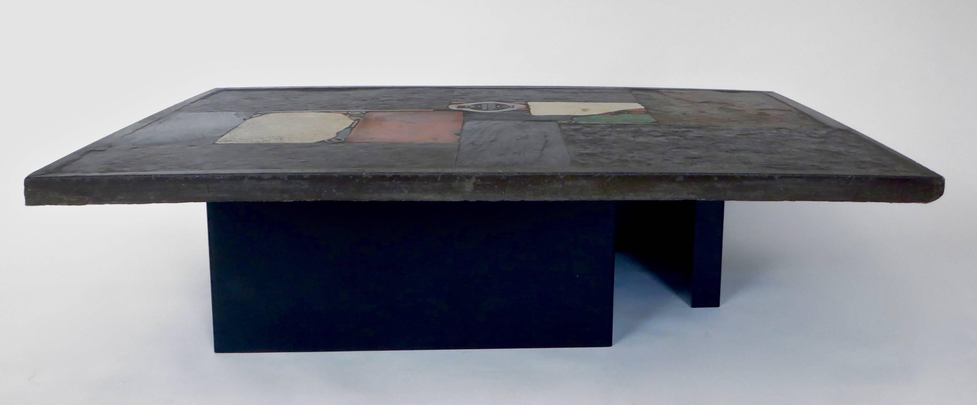 This is a one off unique early piece made of different colored stones, concrete, slate and finished with brass details. Signed by the artist in a brass plate Paul Kingma 1974 Cast concrete plateau, inlaid with stone, ceramic and found object. 47.25