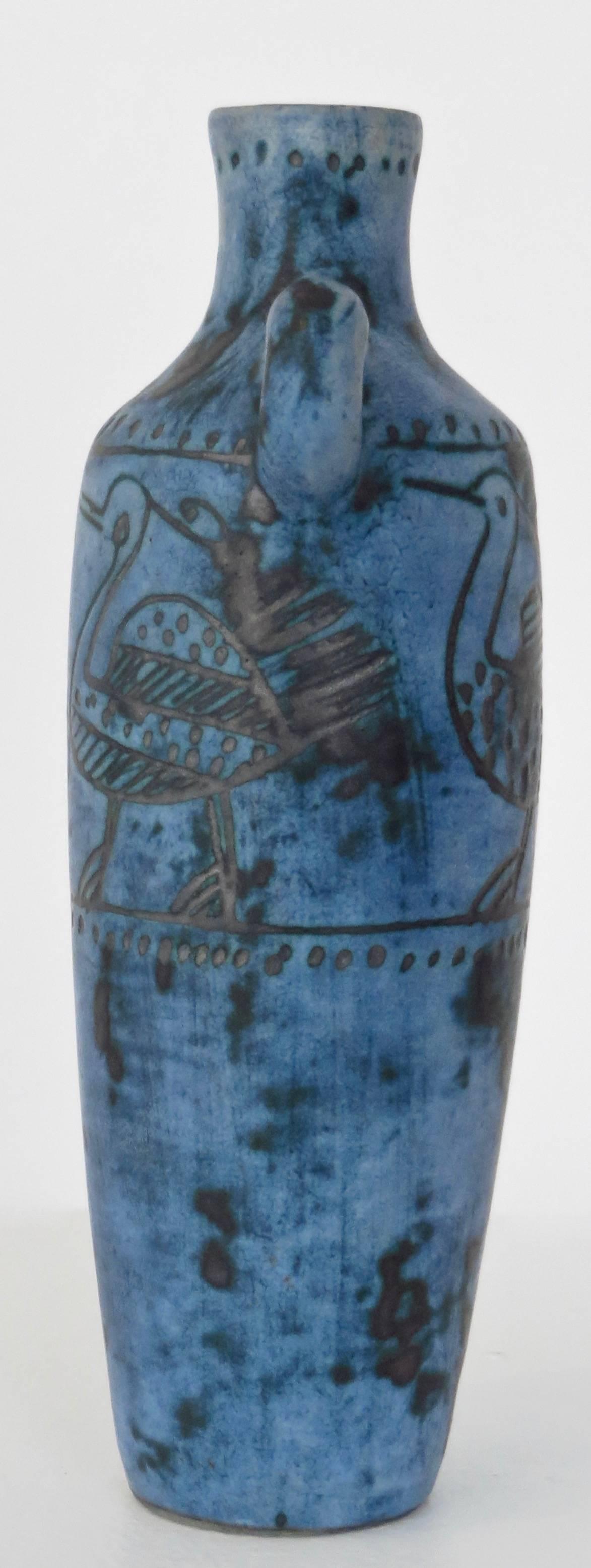 A French ceramic bottle by noted artist Jacques Blin with wonderful image of a bird in his iconic blue glaze. Wonderful detail around the shoulder and neck of the bottle. No chips or restorations. Signed.