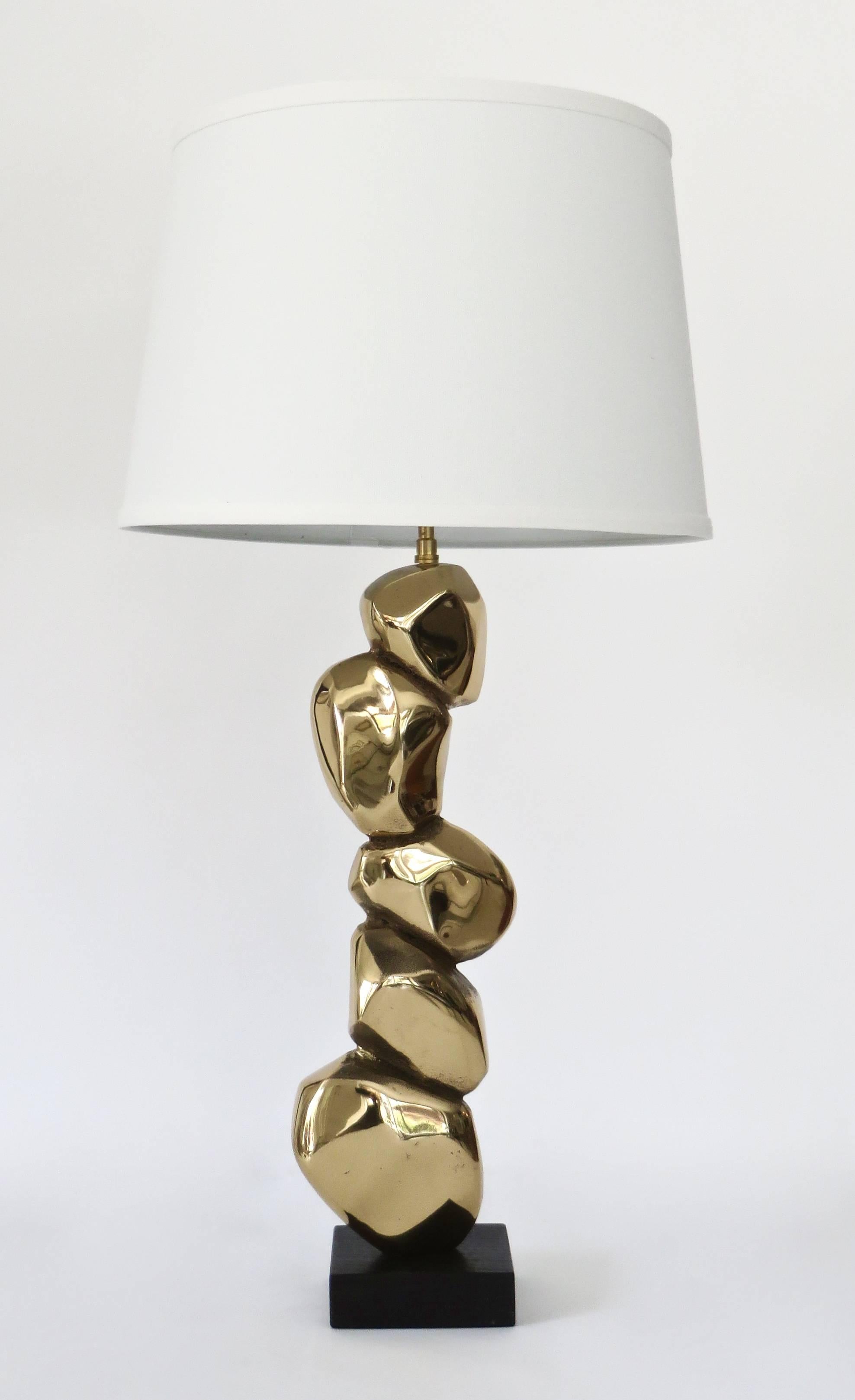 Pair of French sculptural bronze stone motif table lamps by Michel Jaubert. Signed on side M. Jaubert. Composed of five abstractly sculpted bronze stones. Hollow back showing casting. Shades are not included. Rewired for USA overall size of lamp