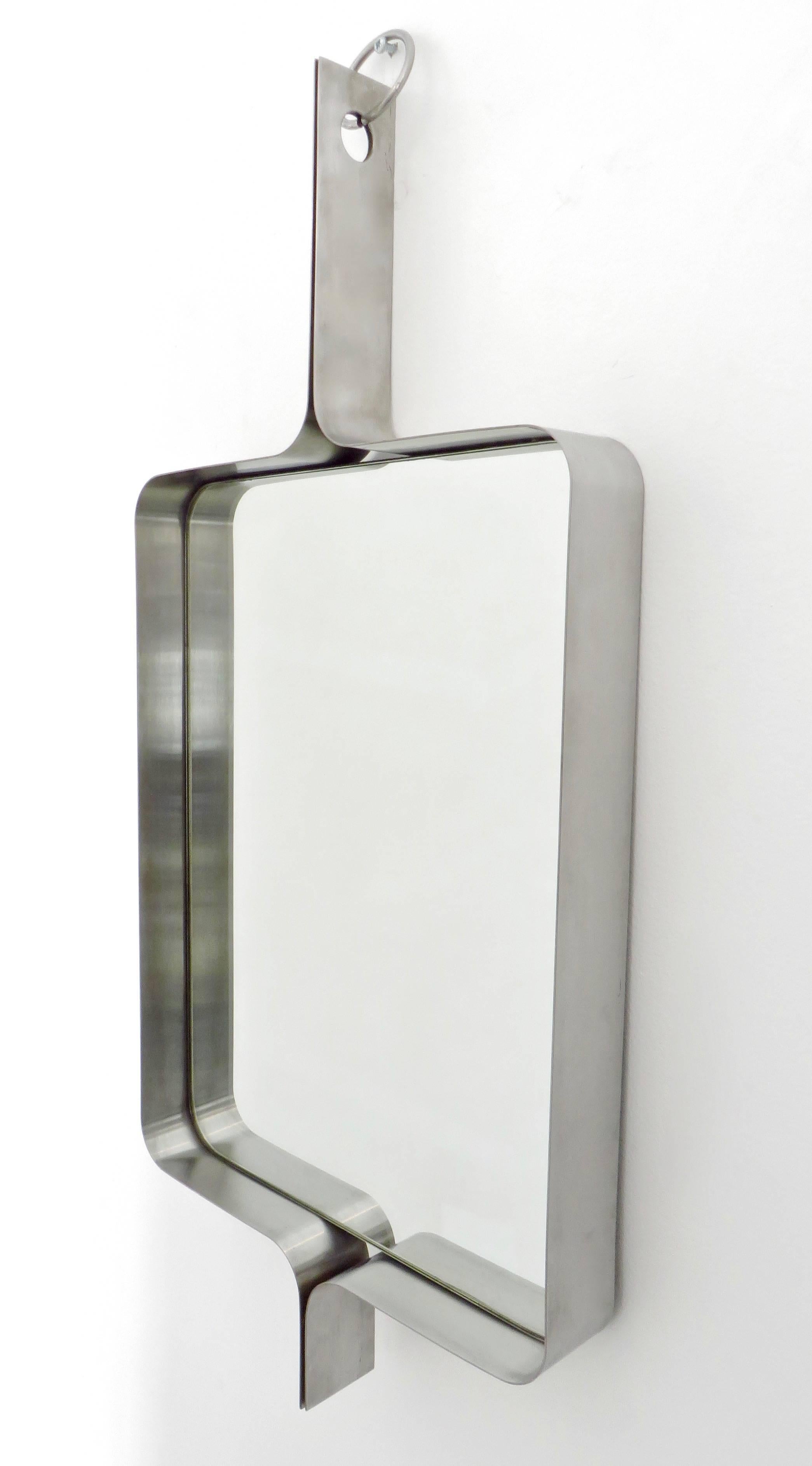 A Xavier-Feal French rectangular brushed stainless steel wall mirror, circa 1970.
Produced by Inox Industrie, circa 1970.
This mirror was previously attributed to Michel Boyer.
A pair available.
Will separate. Price listed is per mirror. 
Excellent