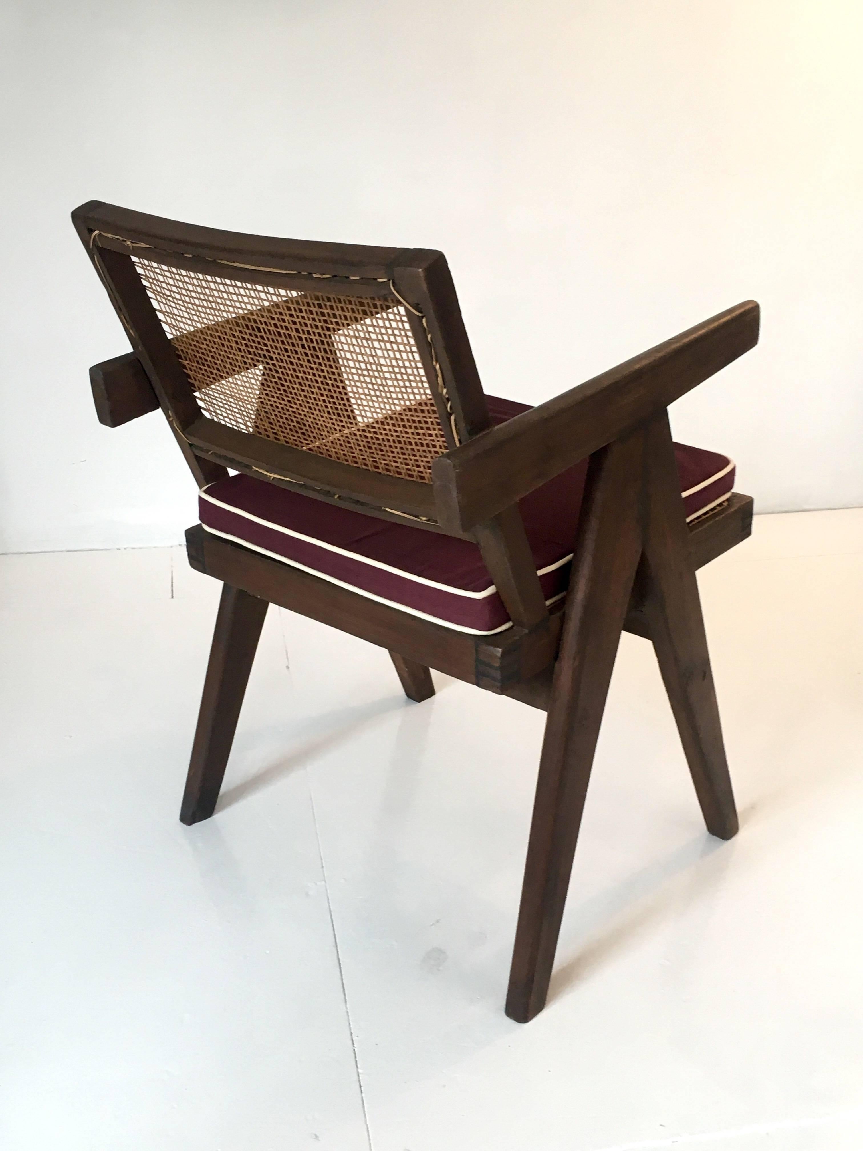 A single armchair called office cane chair by Pierre Jeanneret (1896-1967) from Chandigarh.
In teak with cushion and with bended and slightly curved back.
Cane seat and back, circa 1956.
This example has been restored with a wax finish.
Signs of use