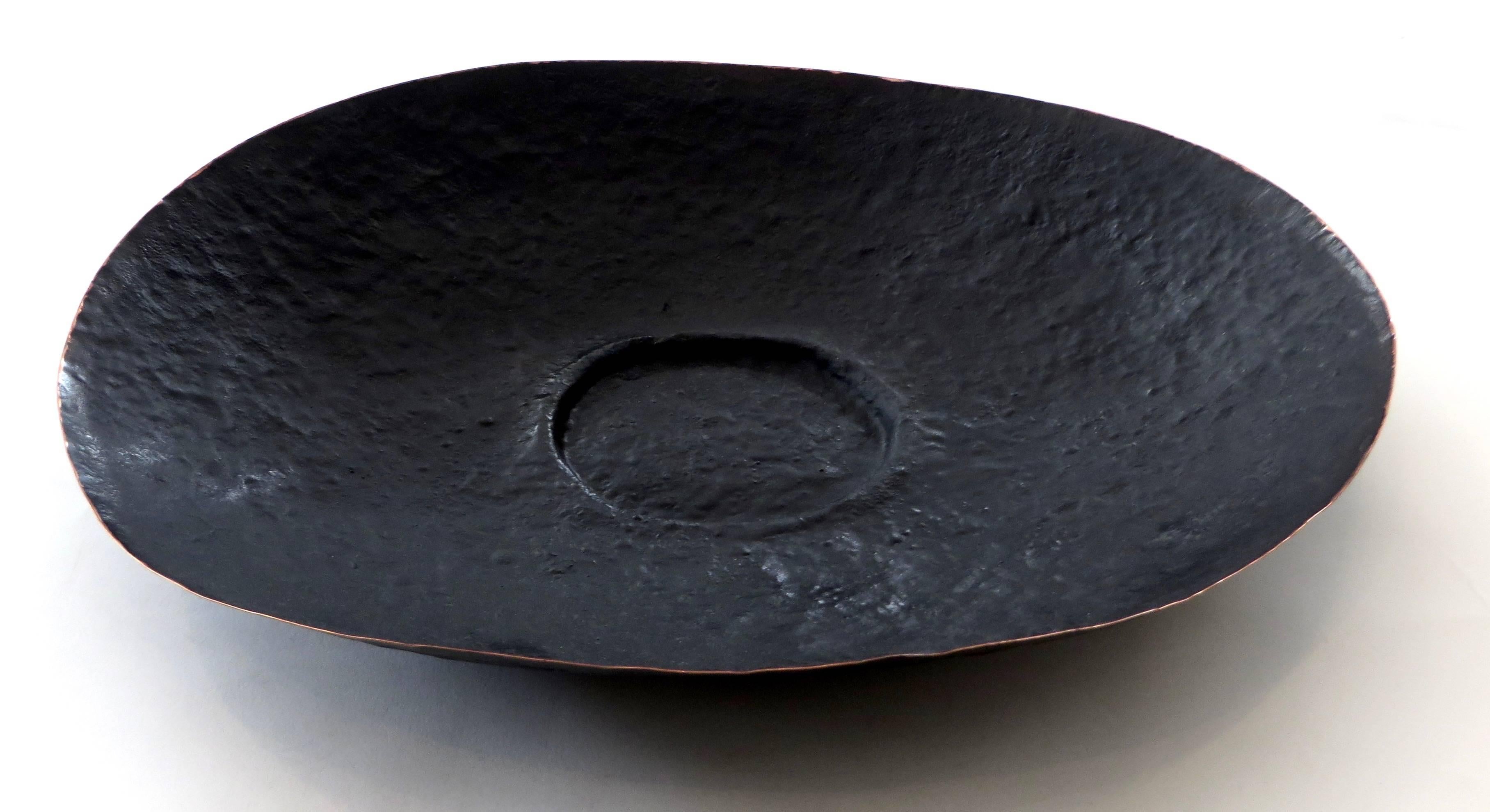 A hand-hammered copper sculptural and highly textured bowl by Hnter Gvtherer in the Poros series.
Each is piece unique.
This bowl features a round depression in the center creating a slight foot.
The surface has a slight high relief with a