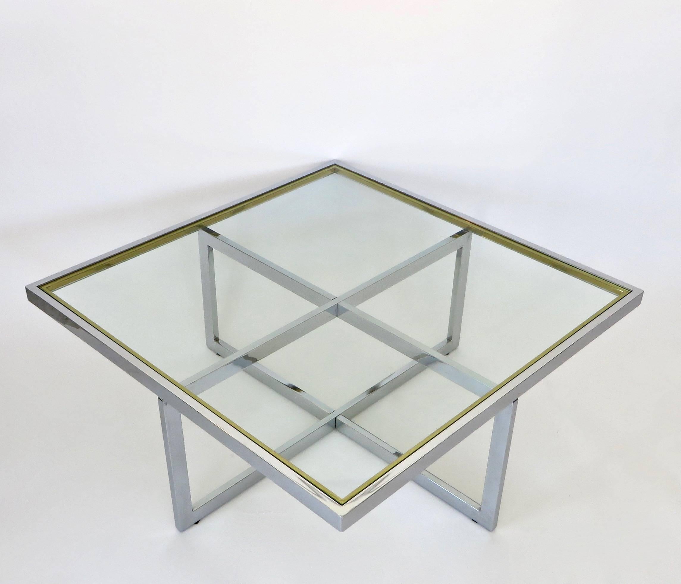 A French chic square chrome and glass coffee table with brass accent by Maison Charles et Fils, circa 1970.
The chrome is the predominant metal in this coffee table with brass trim accent in the top portion. 
No pitting or rusting on the chrome.