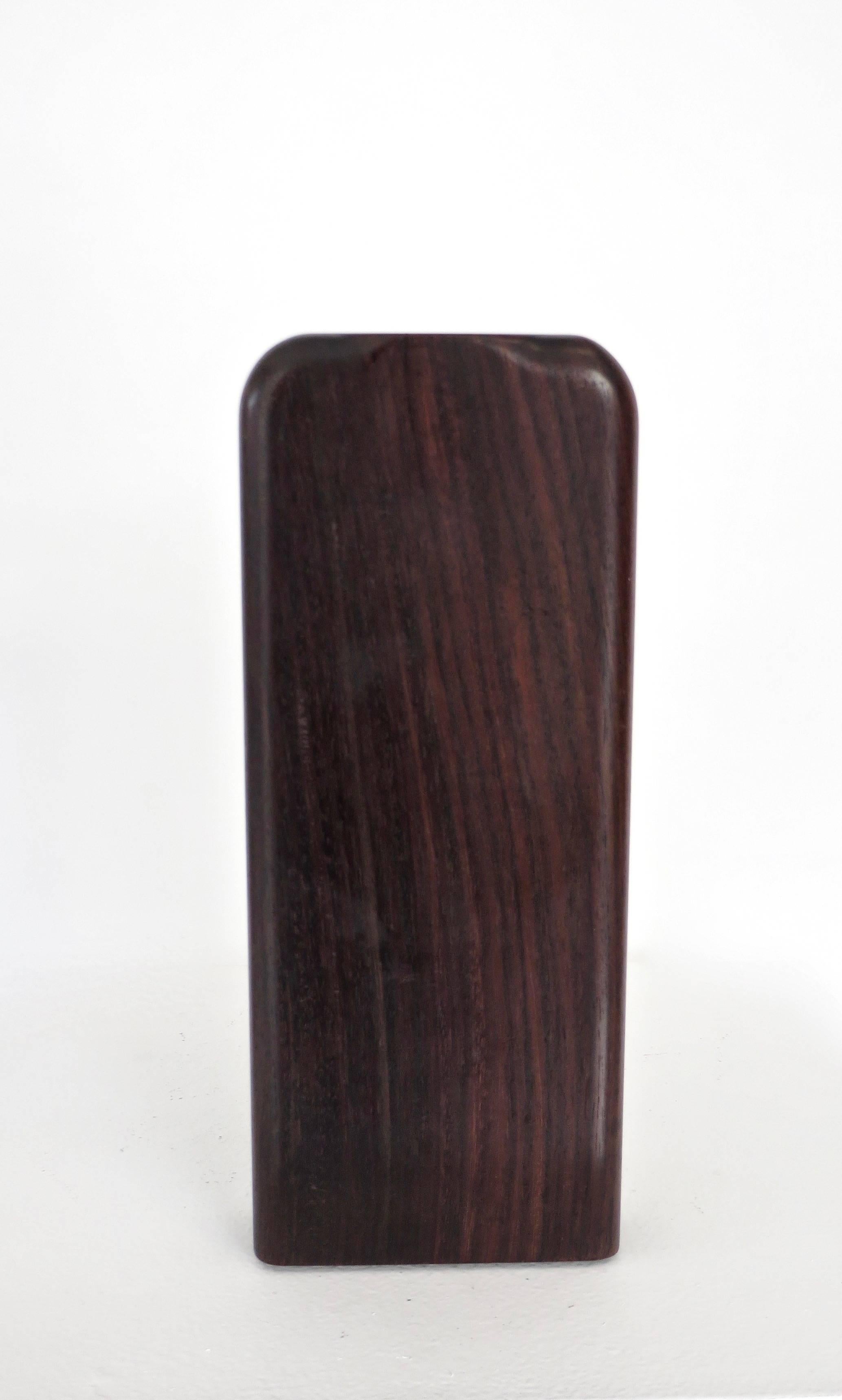 A solid rosewood Minimalist style flower vase with a copper tube liner. 
A beautiful piece of wood with no attribution. 
Artisanal quality obvious from the copper tube liner that fits perfectly. 
Unsigned.