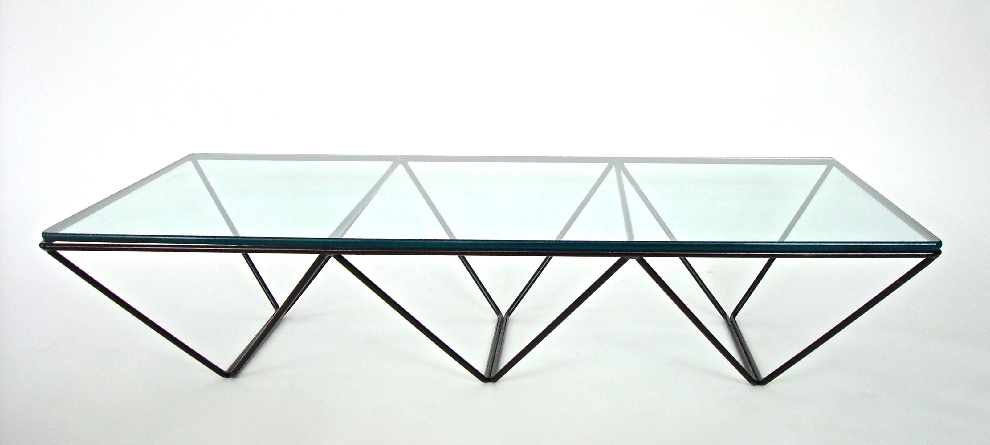 The architectural Alanda low coffee table by Paolo Piva was editioned by B&B Italia, circa 1980. This example is highly desired. It has three sections making it a rectangle rather than a square. Welded enameled black powder coated steel rods with a