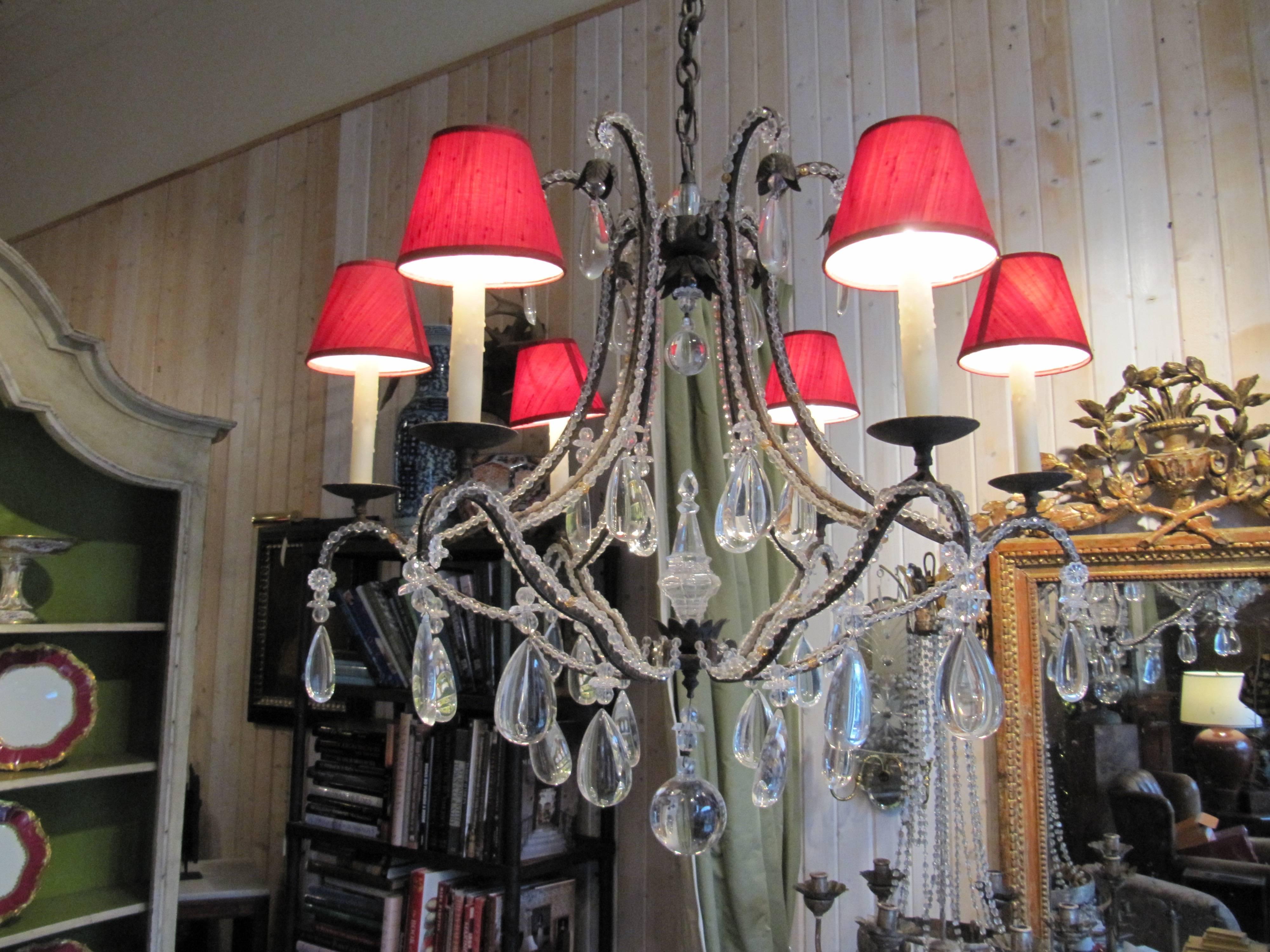 A beaded wrought iron six-light chandelier.