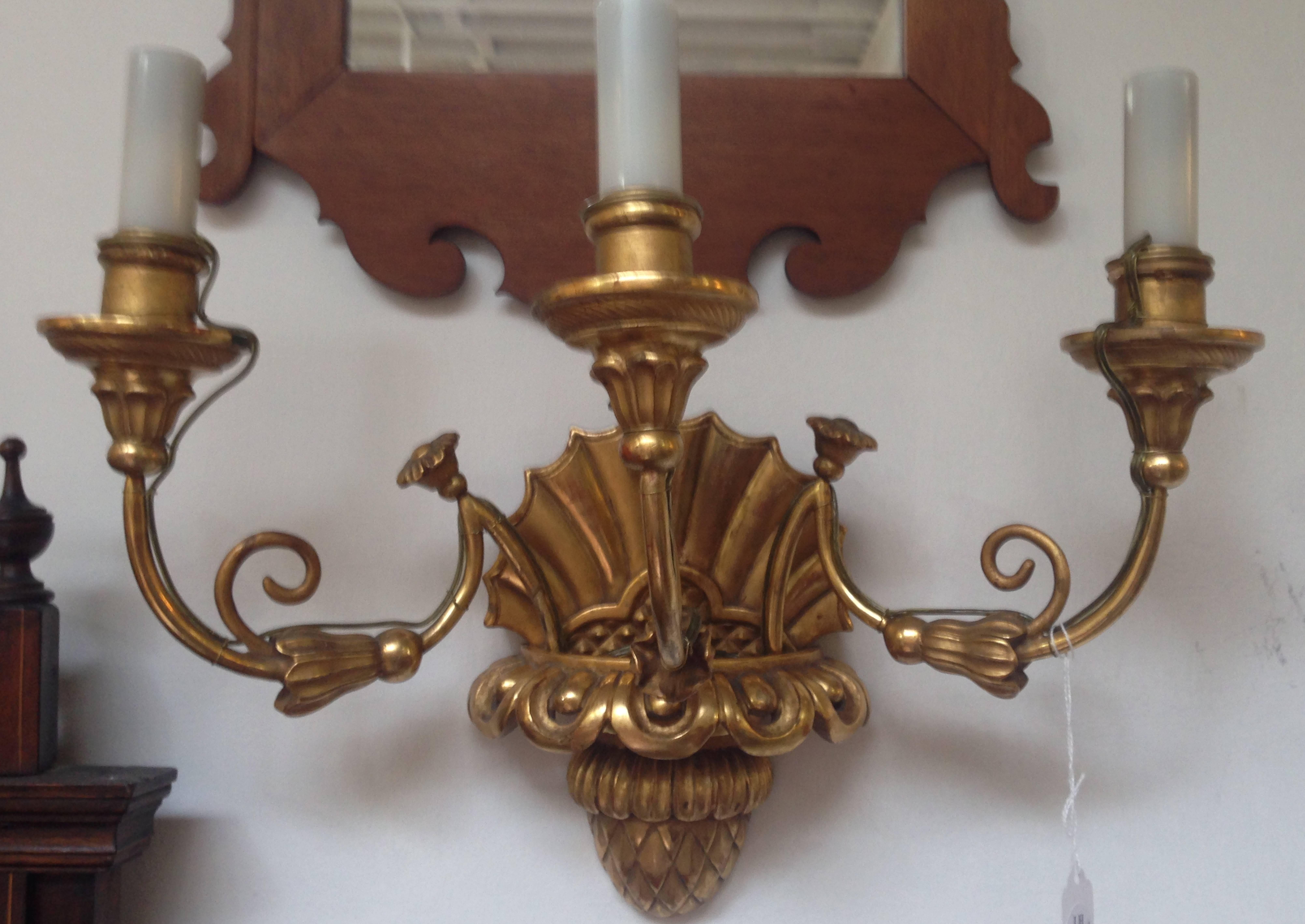 A pair of Biedermeier giltwood three-light sconces. Measures: Height 12 1/2 x width 17 inches.
