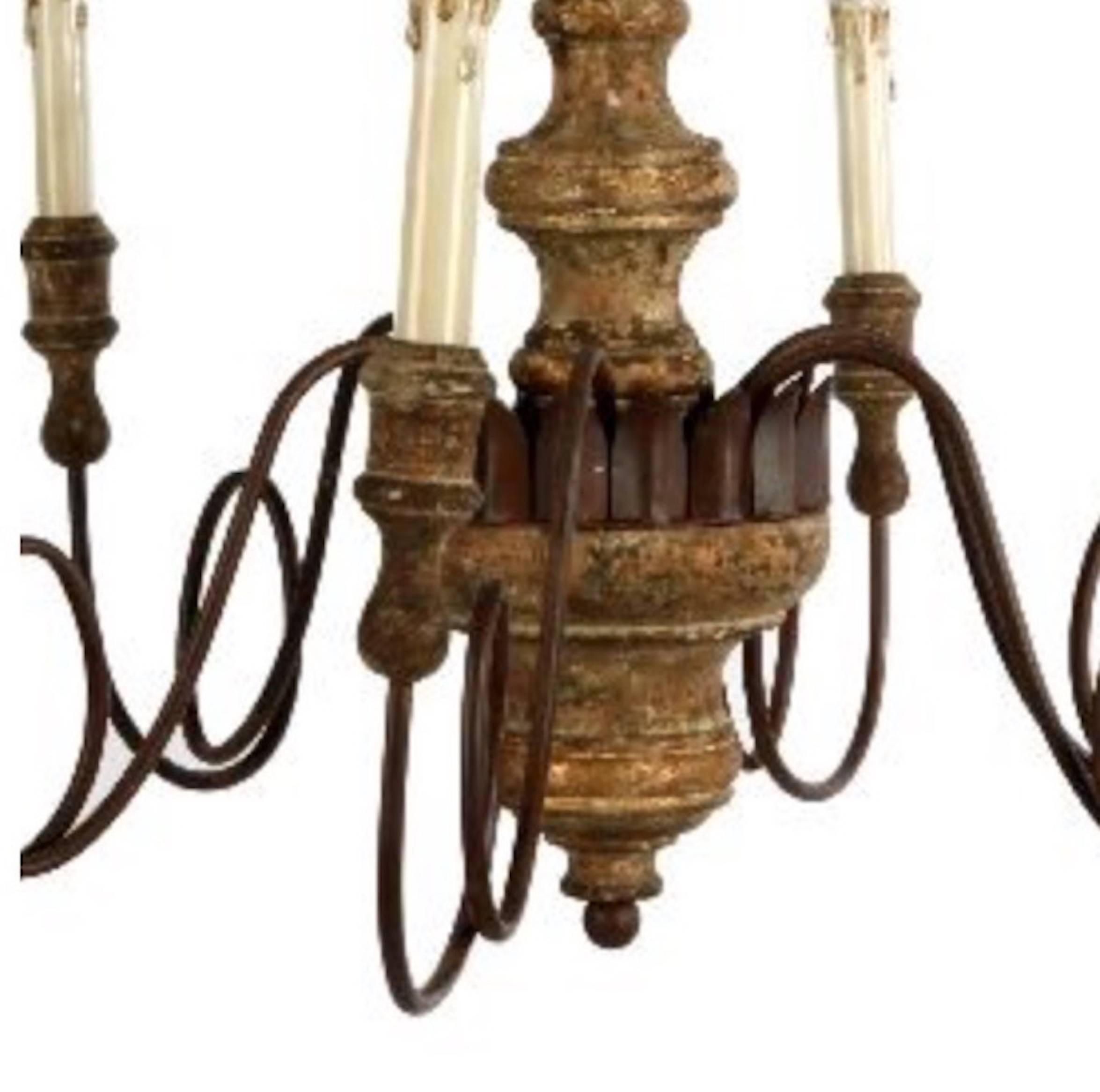 Set of four Italian style carved wood and iron chandeliers with lovely patina. Newly wired and ready for installation, includes chain and canopy assembly.