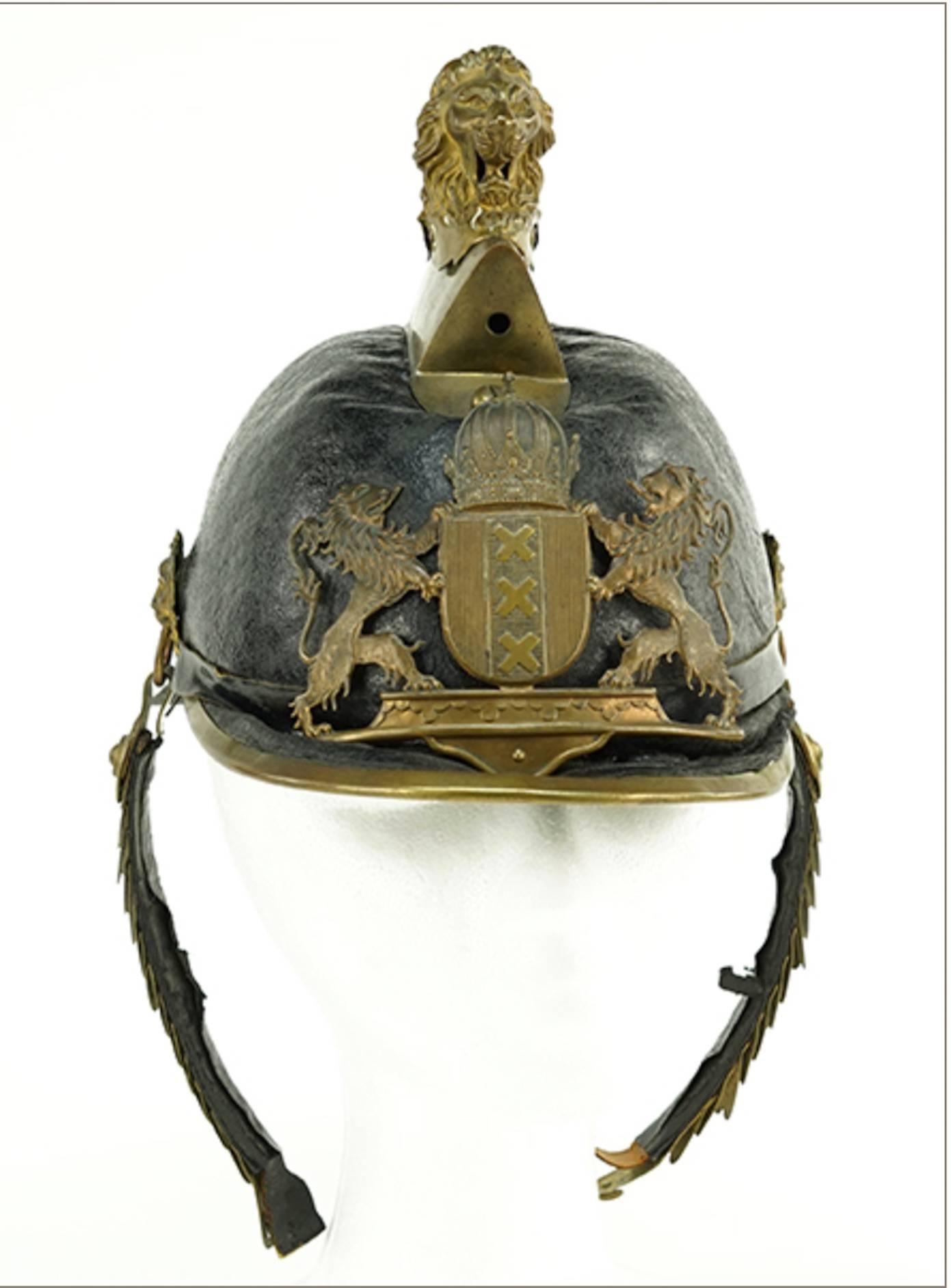 Two 19th century Austrian parade pickle helmets. Letter with gilt metal mounts.