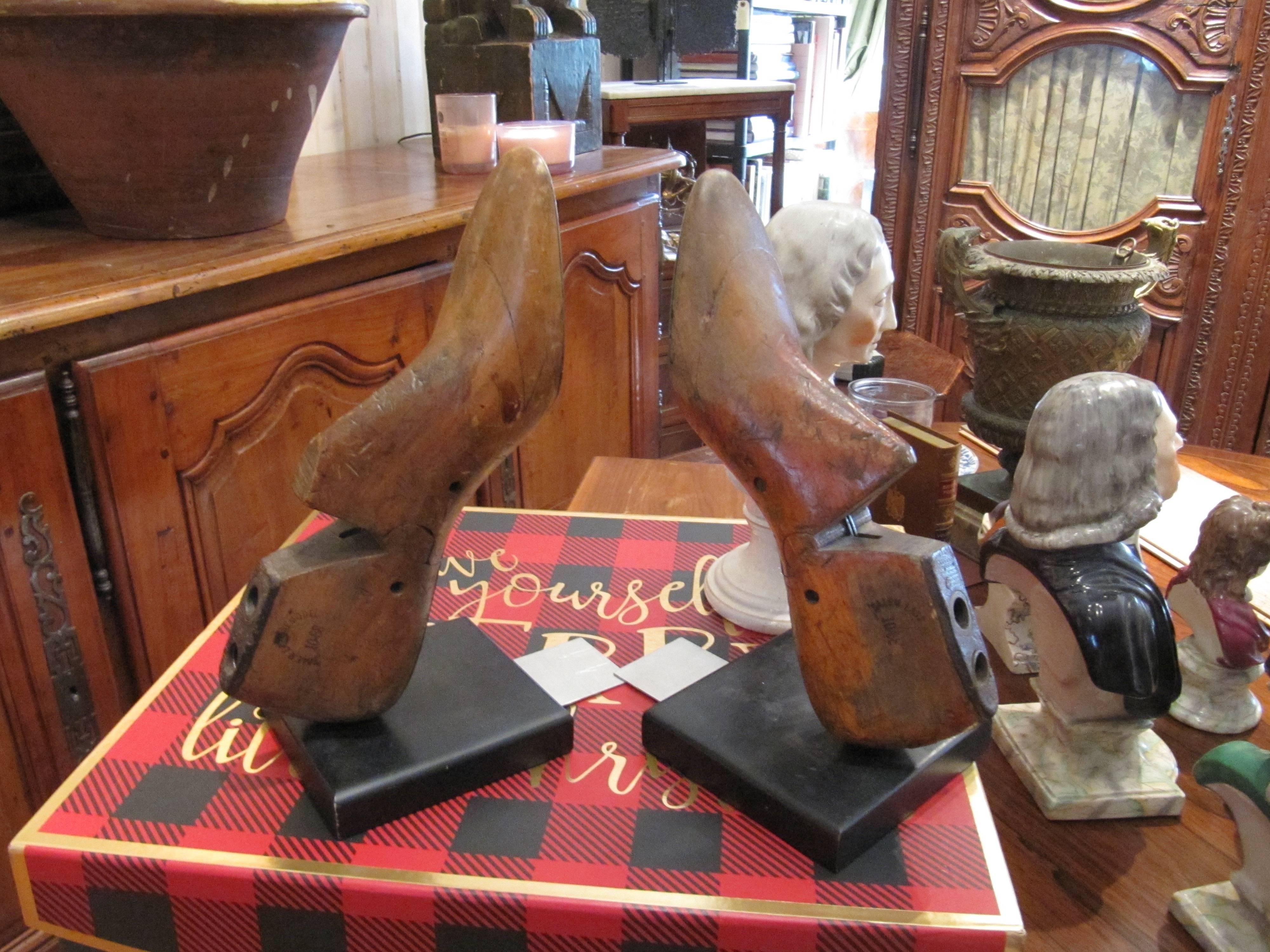 One pair of charming wooden shoe moulds mounted as bookends, comes with four leather bound books.  Feel free to call with further questions.