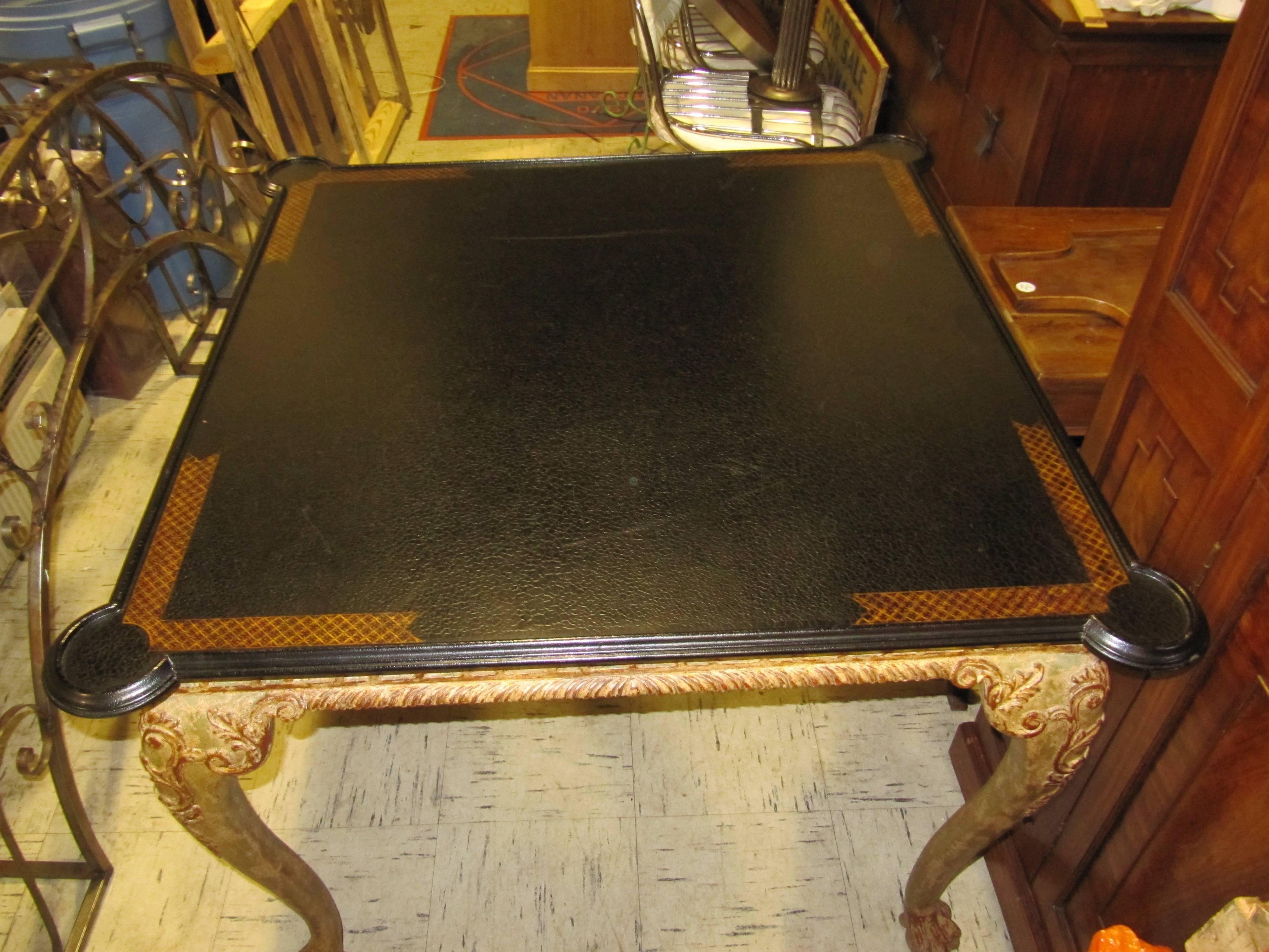 A William Switzer card table. Black crackle glaze top above a Chippendale style gold painted wood base.