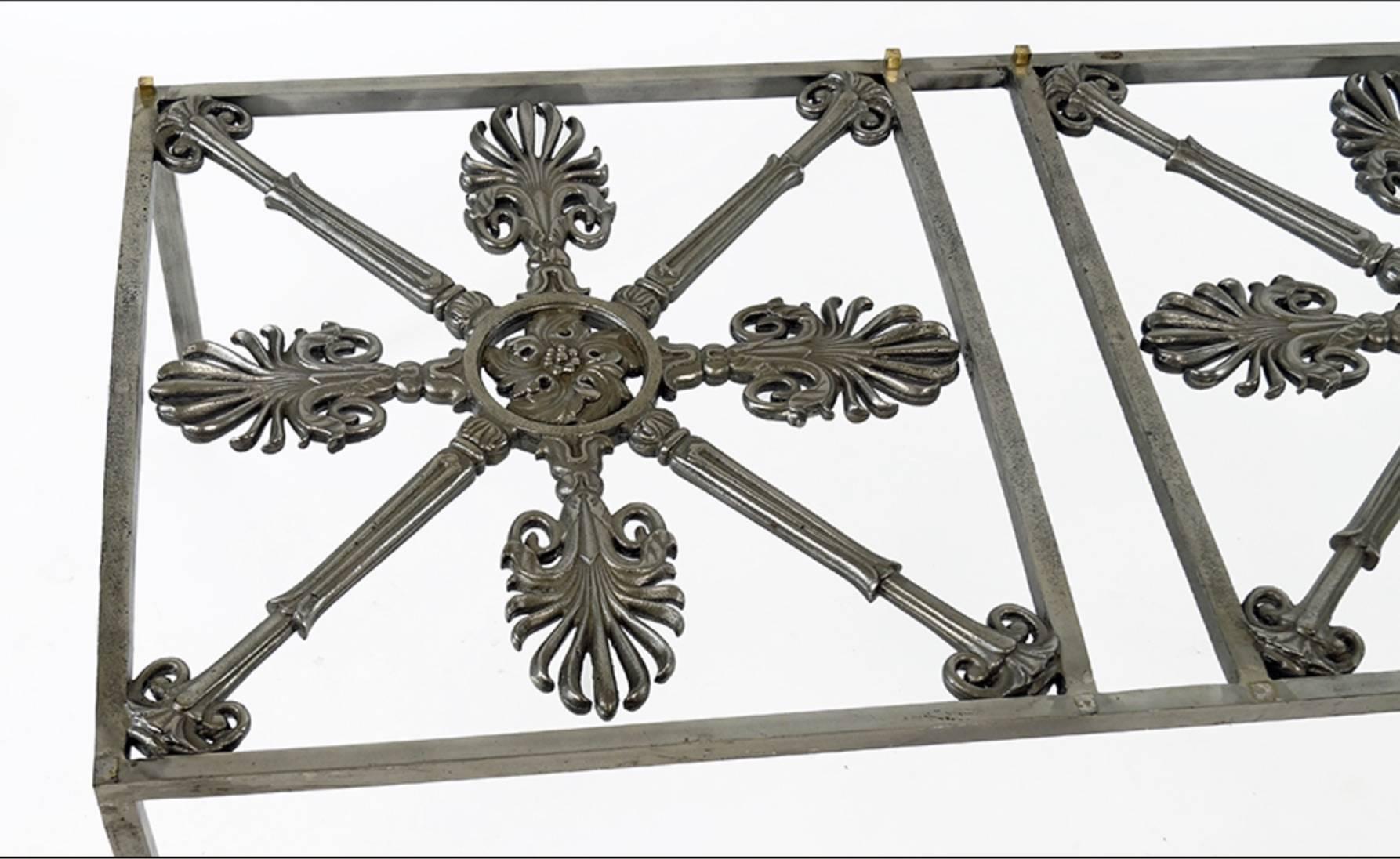 An Iron Cocktail Table Made Of Architectural  Elements. Patinated iron table with non figural decoration and raised on four straight legs
18