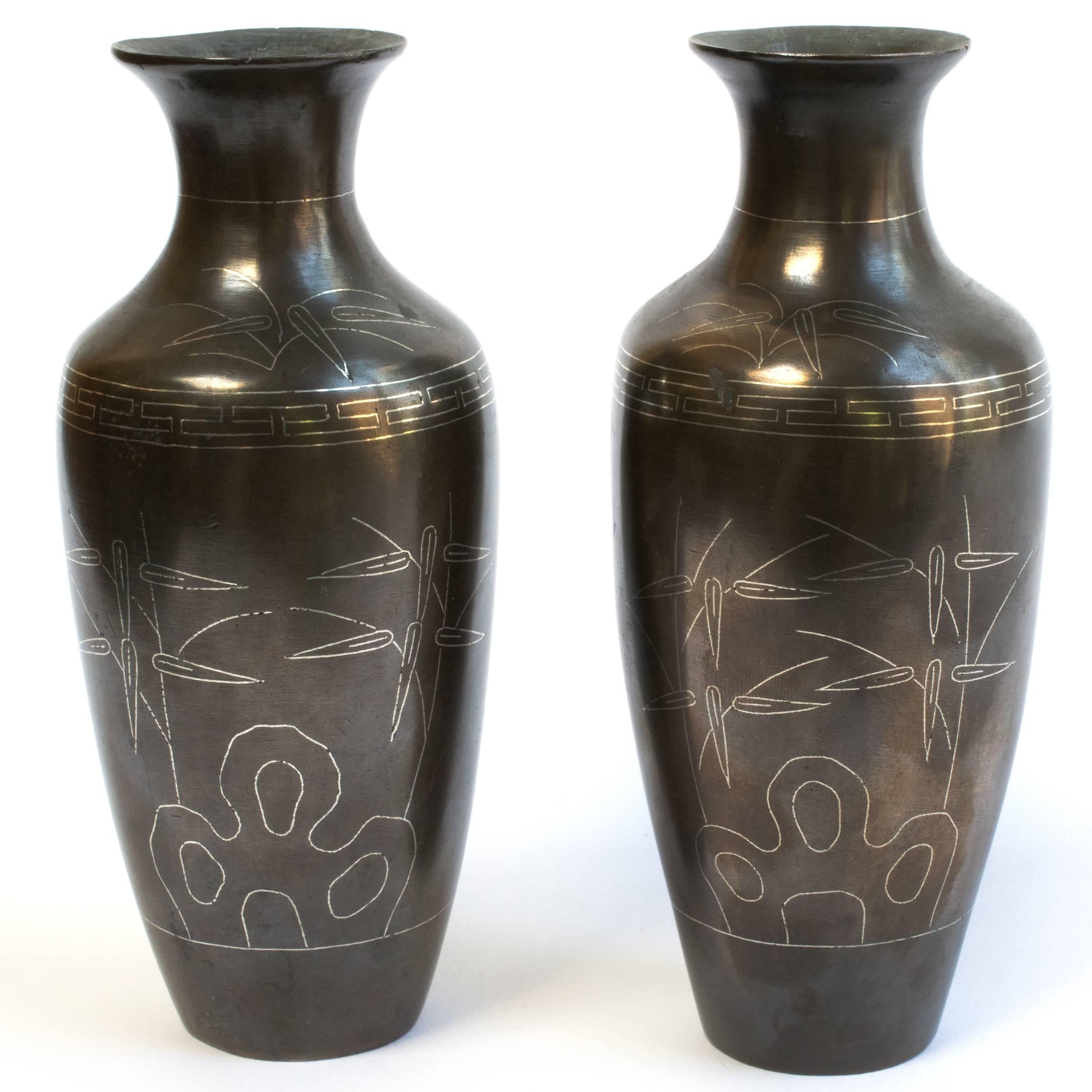 This pair of bronze vases was made in China over two centuries ago. They have flaring lips and striking profiles often referred to by connoisseurs as “turnip-shaped”. Each vase is decorated with a silver inlaid scene, highly skilled craftsmen would