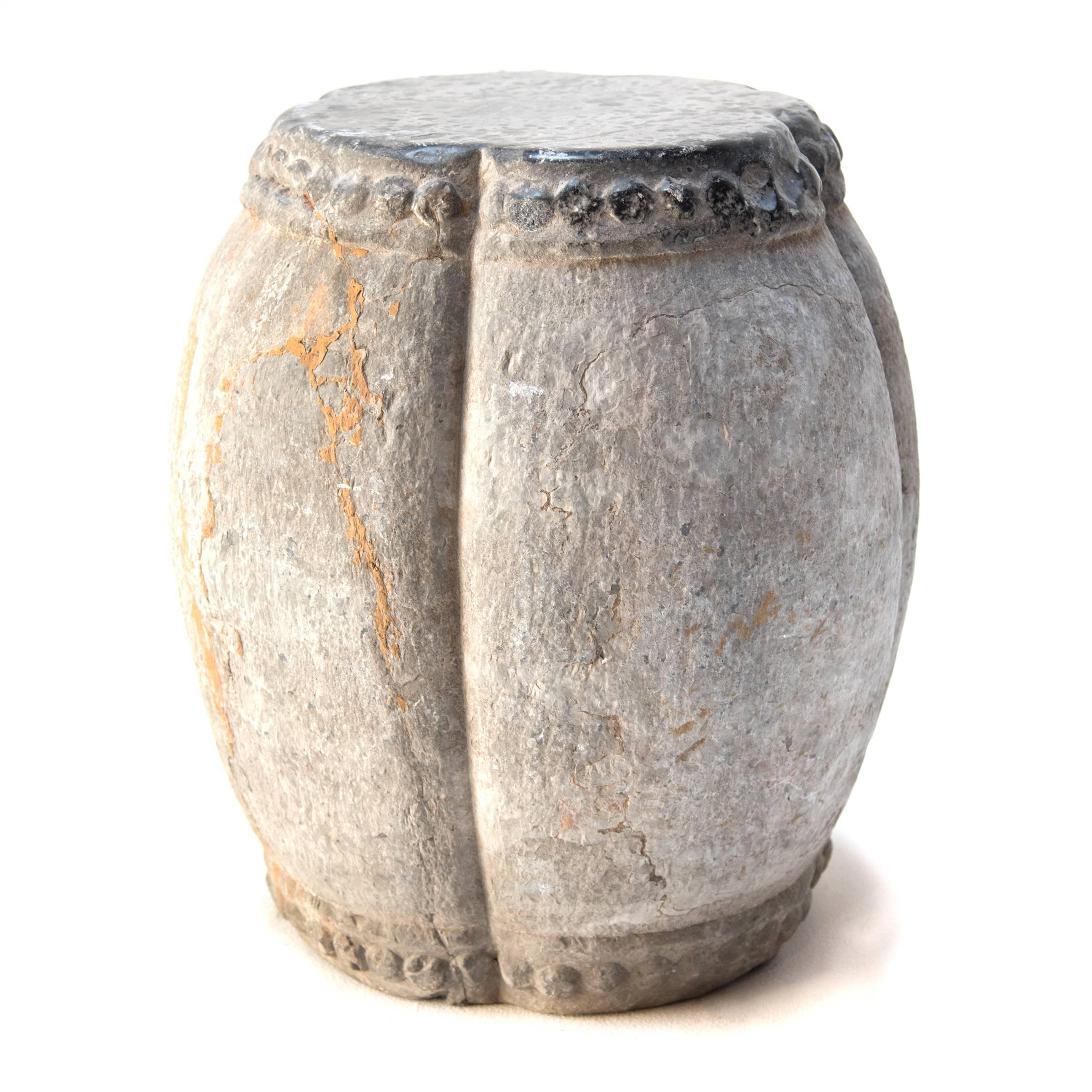 This Northern Chinese 19th century white marble drum-shaped stool originally functioned as an architectural support. Around both its top and bottom, a pattern of boss-head nails imitates those used to stretch a skin on an actual drum. At once humble