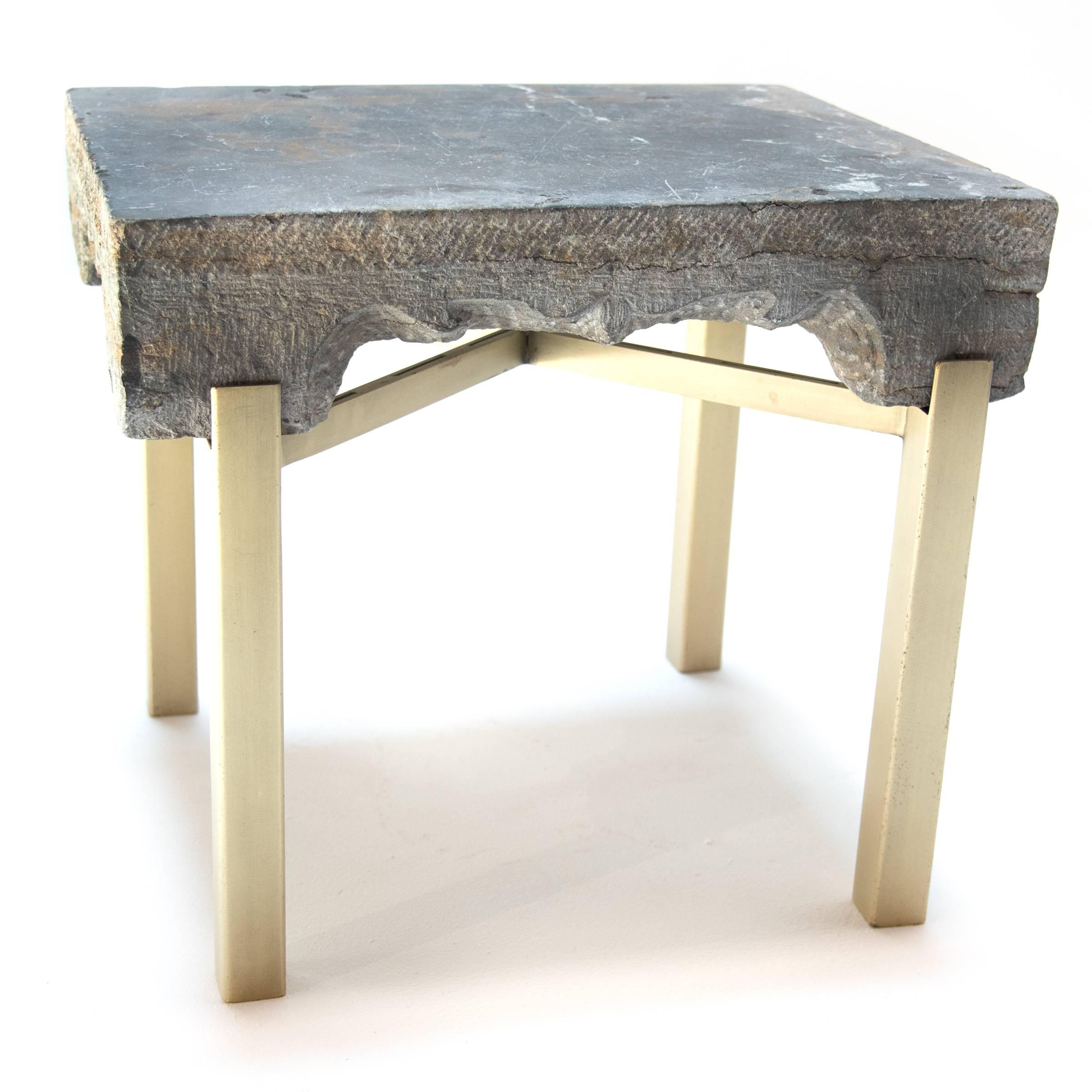 Early 19th century Chinese hand-carved limestone stand with brass-plated iron legs.
