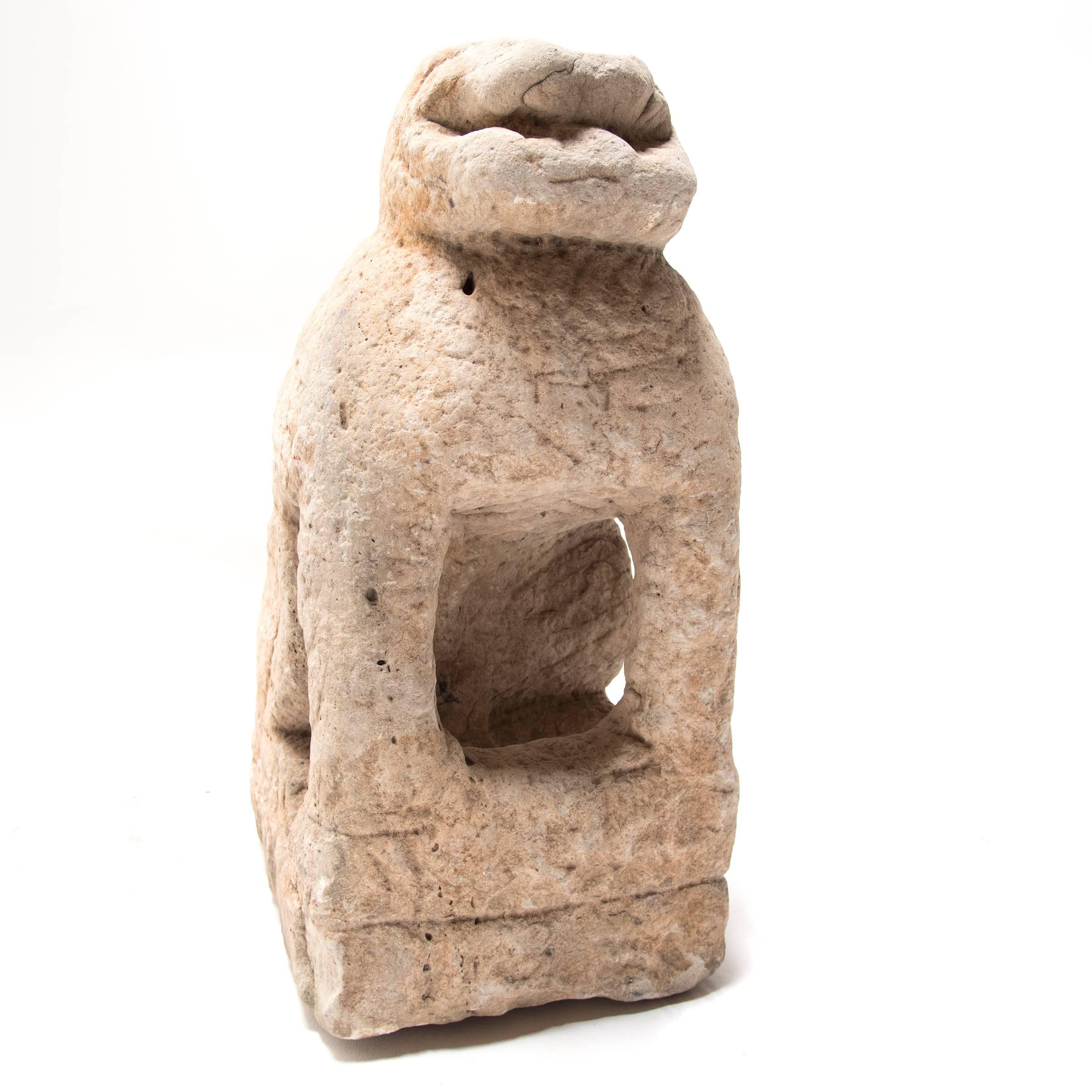 This seated sculpture was carved over 400 years ago during the Ming dynasty out of a single block of limestone. It was discovered in the Shanxi region of China and is believed to represent a seated lion, a protector, well worn by time. The history