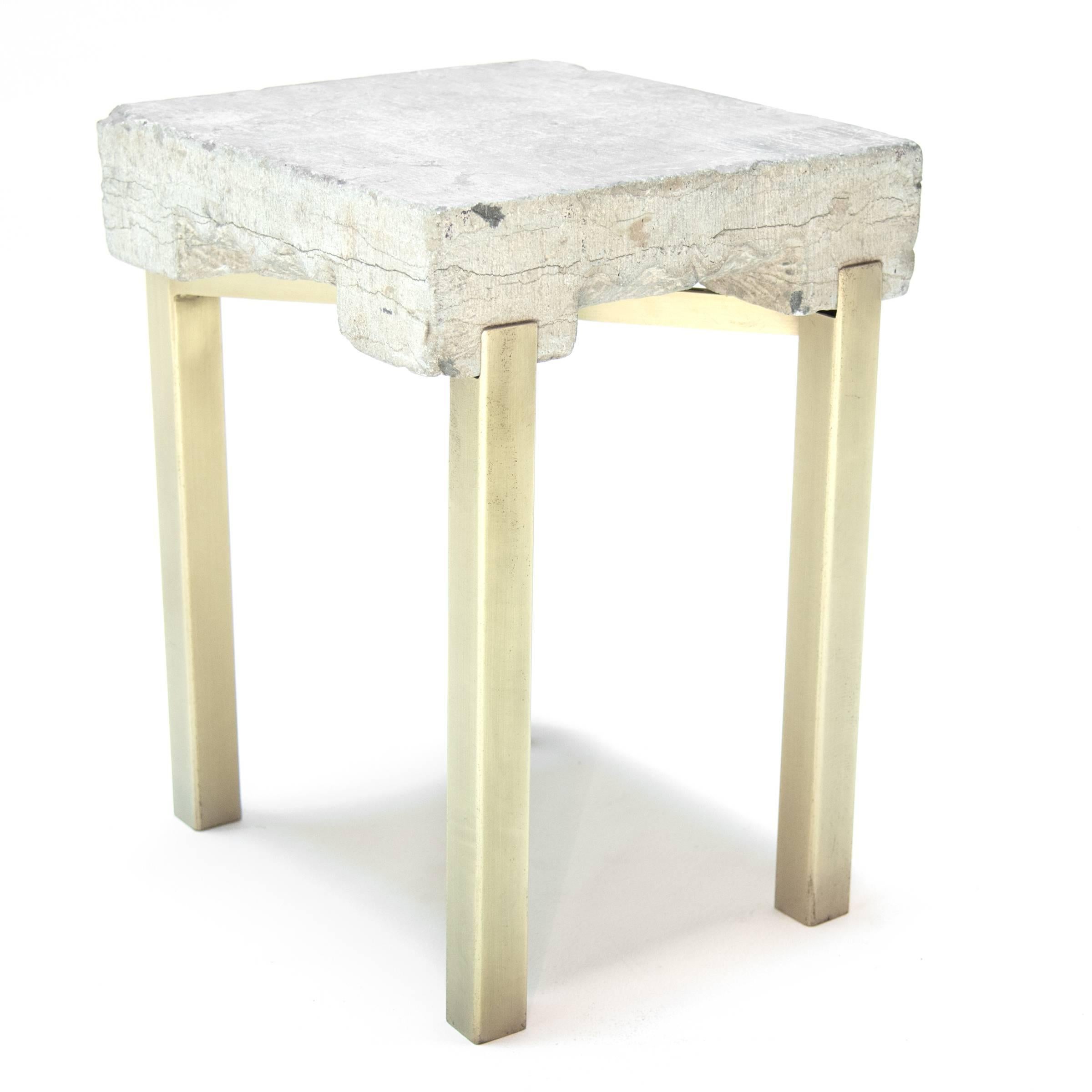 This table marries an 18th century ornately carved limestone block that was traditionally used as a surface for washing fabrics with a brass plated contemporary steel base. It is an exquisite study in contrast: the clean lines and form look