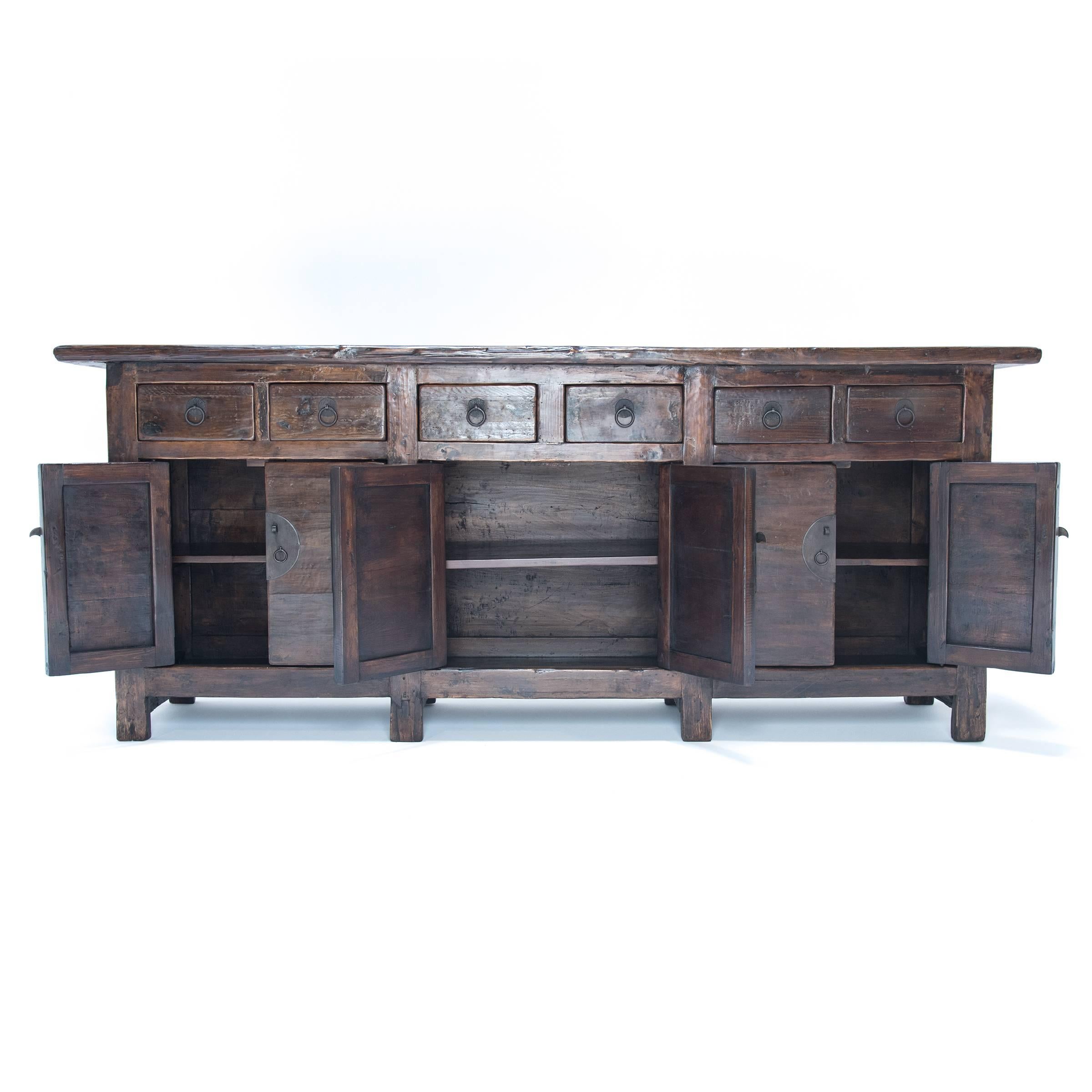 This elmwood coffer is joined together like a tight puzzle with traditional Chinese mortise and tenon construction. The joints are visible and beautiful elements of the overall simple design. The wood grain runs horizontally on the six doors and