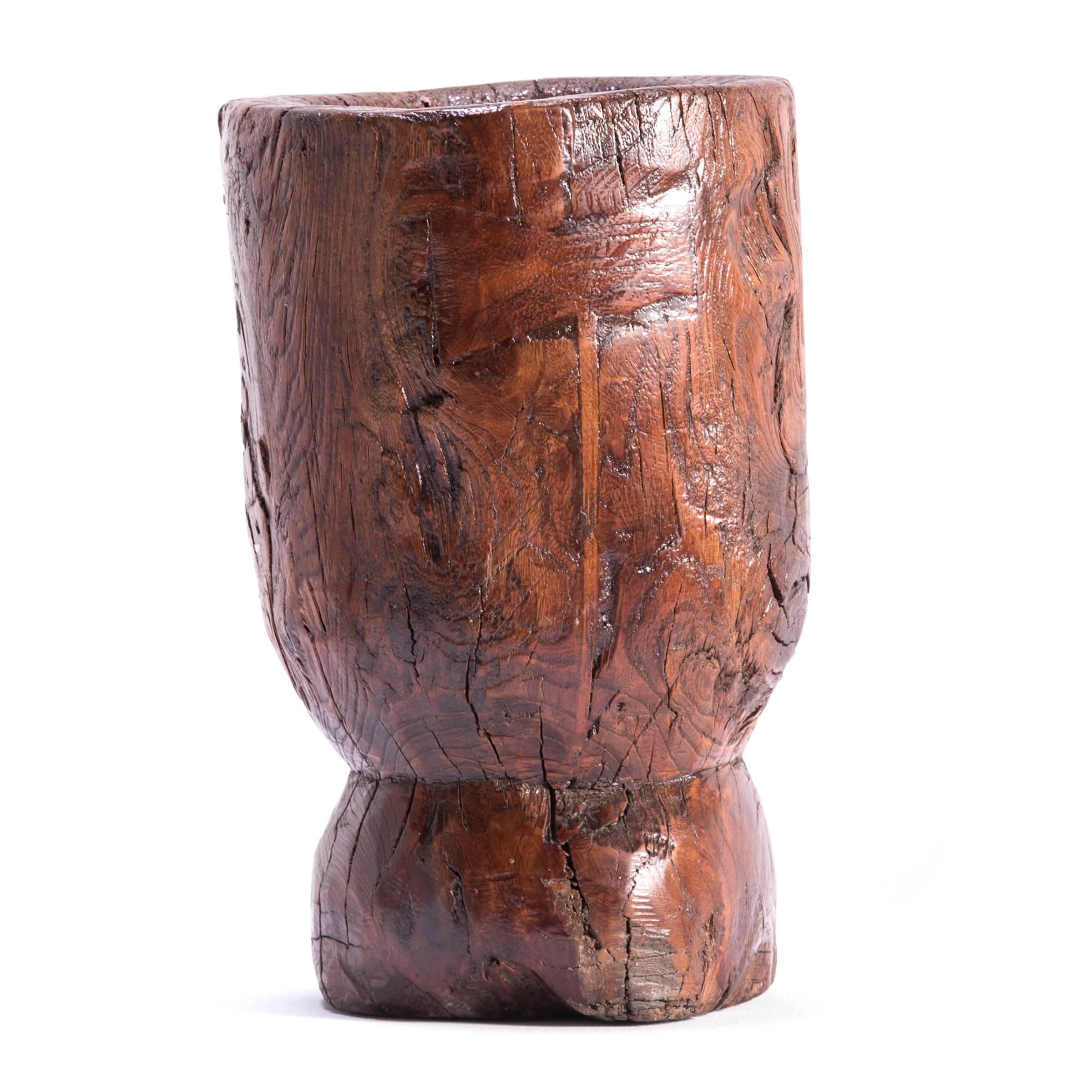 This organically shaped vessel was carved from a single piece of wood over 150 years ago in Mongolia and was likely used as a mortar by a traditional Chinese apothecary to grind natural ingredients for special medicines. It is carved out of a wood