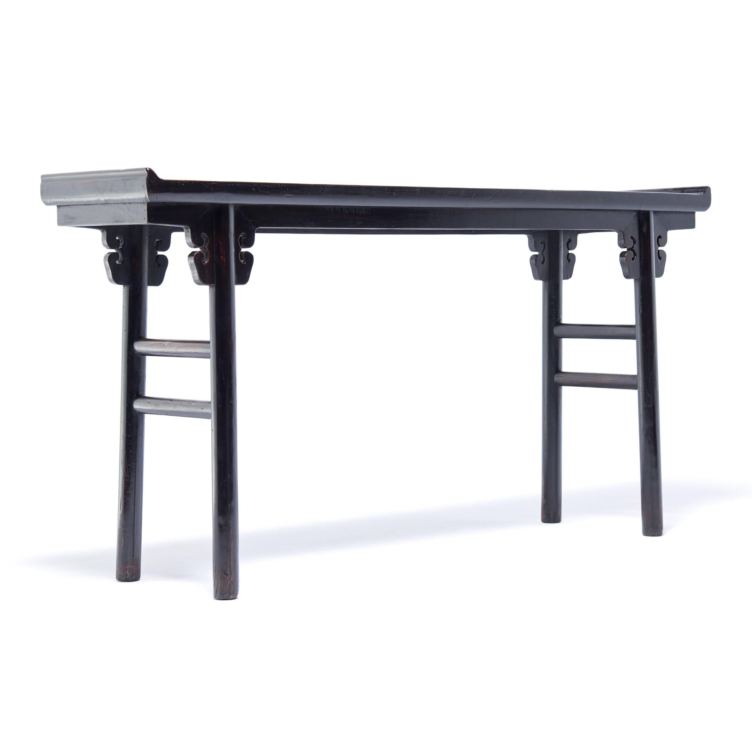 Slender, long tables like this are often referred to as “altar tables.” In ancient China they were used to hold musical instruments or display items of beauty and wealth such as jade, arrangements of flowers, or porcelain vases. This elegant elmwood