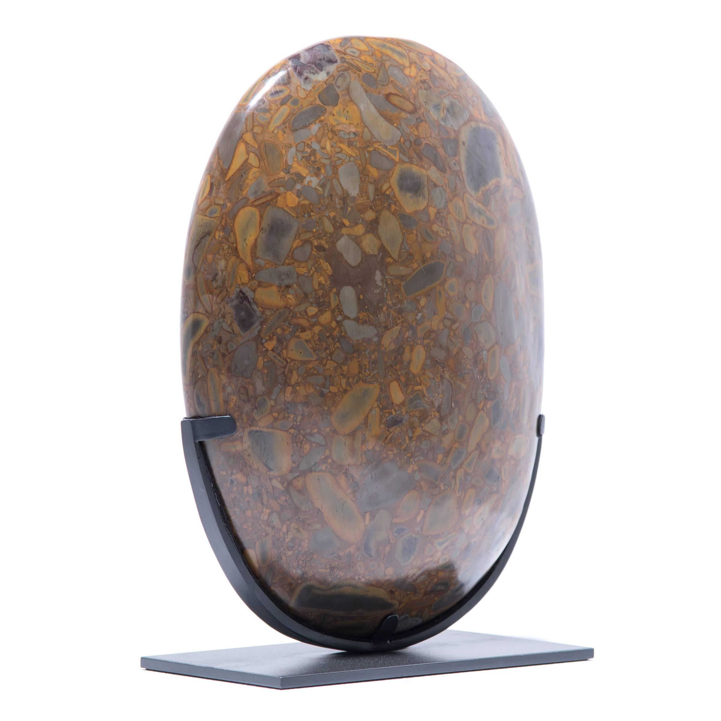 Puddingstone is named for its unique composite nature, suspending numerous multicolored pebbles that resemble raisins in a pudding. Historically, it has been favored by artists and calligraphers as an ideal surface on which to place scrolls for
