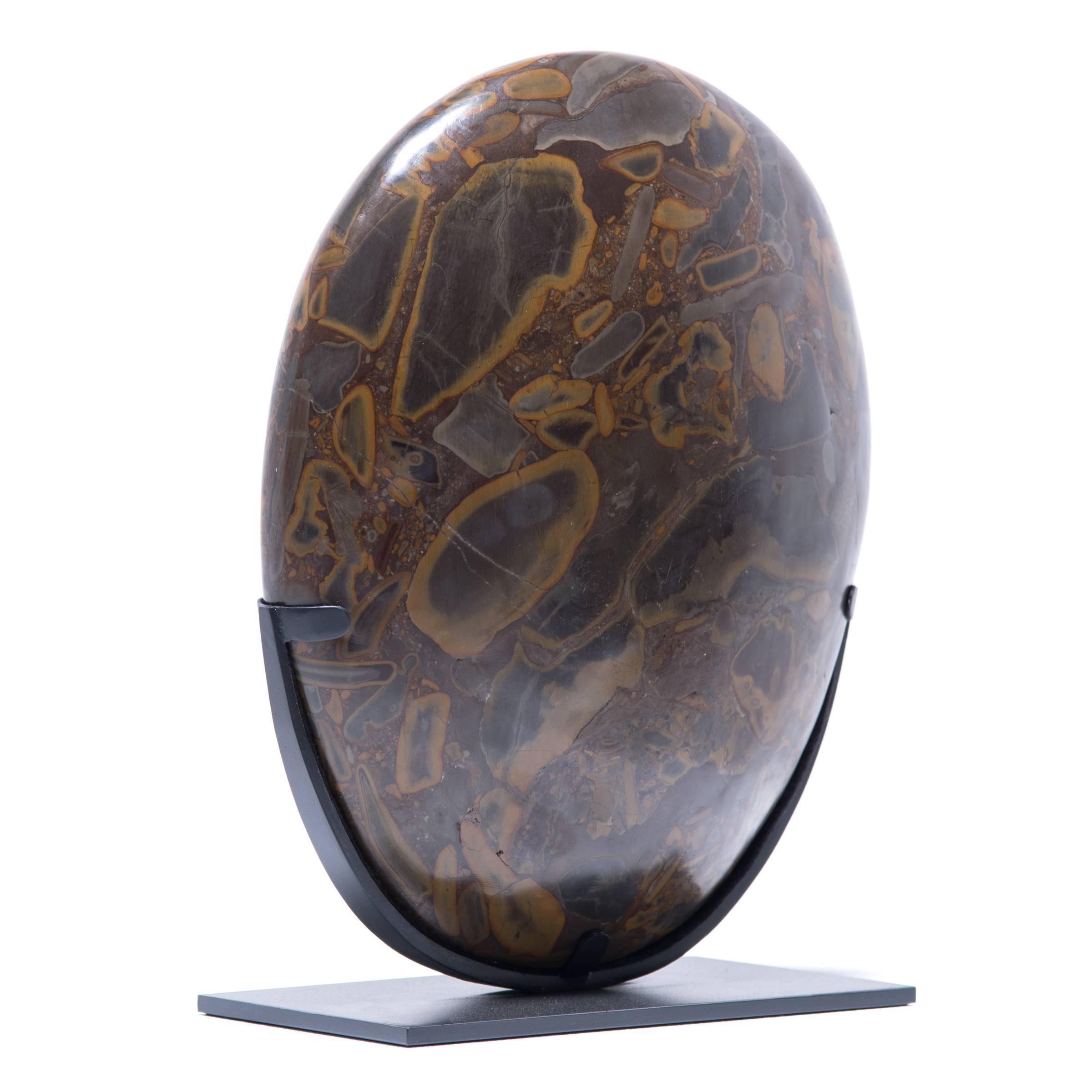 Puddingstone is named for its unique composite nature, suspending numerous multicolored pebbles that resemble raisins in a pudding. Historically, it has been favored by artists and calligraphers as an ideal surface on which to place scrolls for
