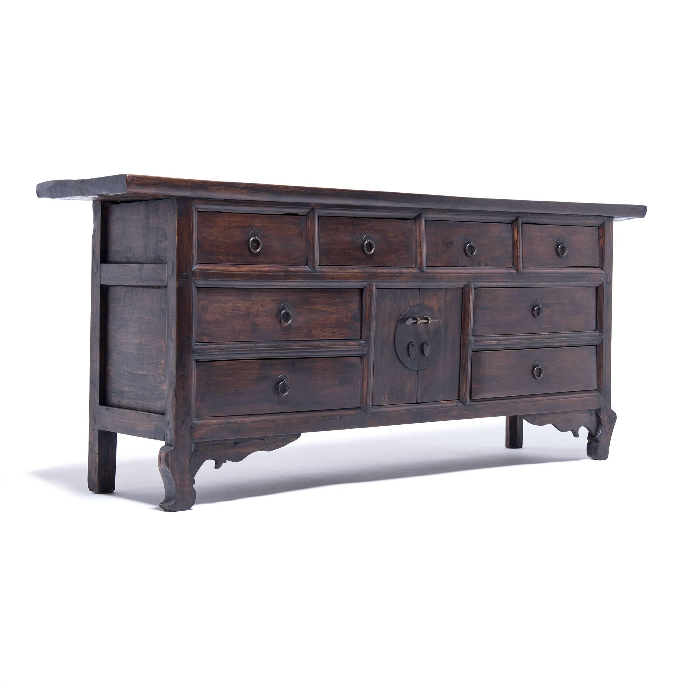 Chinese artisans often weave stories and symbolism into their furniture designs. This coffer has eight drawers because the Mandarin word for “eight” sounds likes the word for prosperity. The quality of the workmanship is evident in the concealed