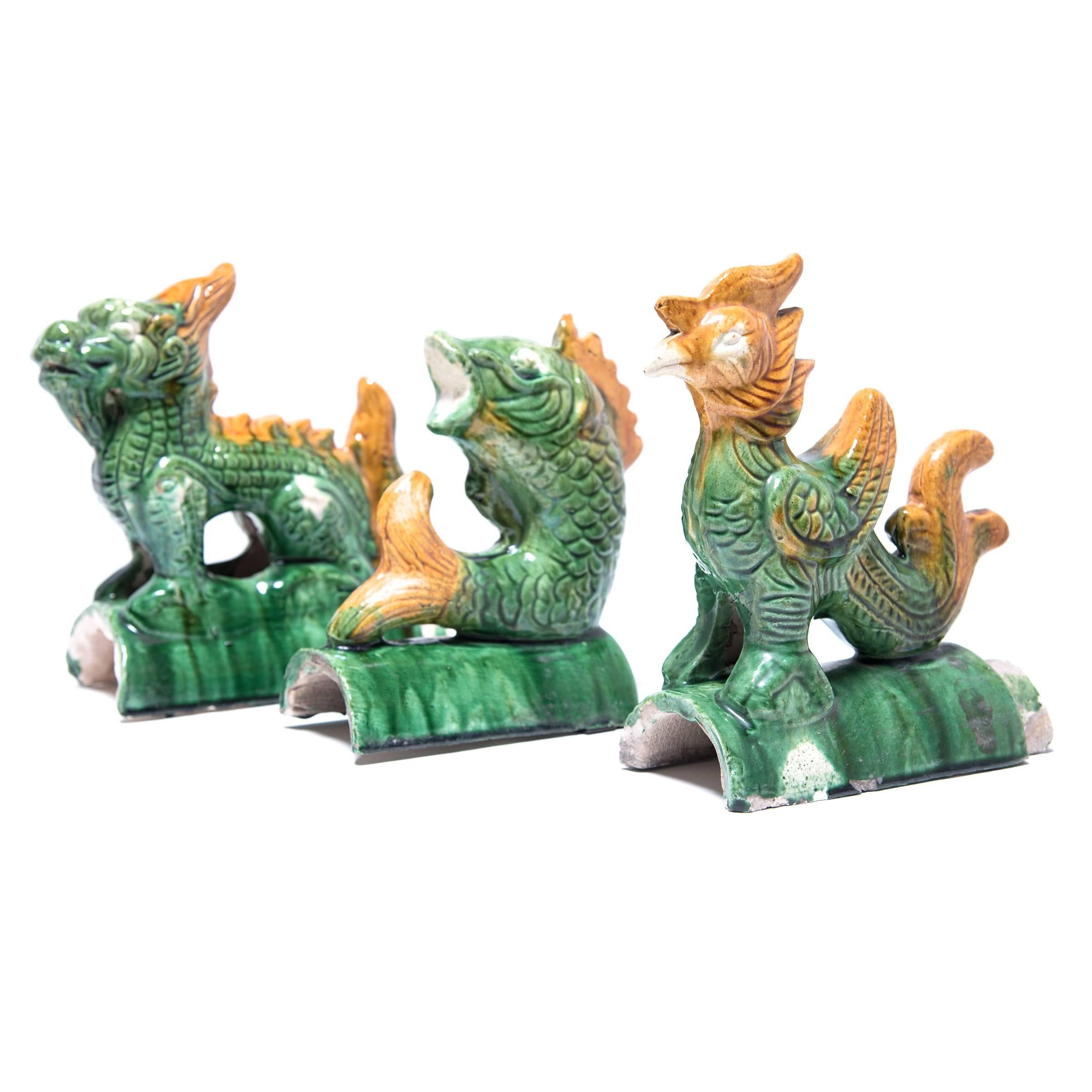 According to ancient Chinese belief, roofs held a place between the mortal and spirit worlds and so eaves and ridges were often decorated with gods, animals, or mythical beasts. These Celestial Roof Tiles depict an animated fish, a dragon and a