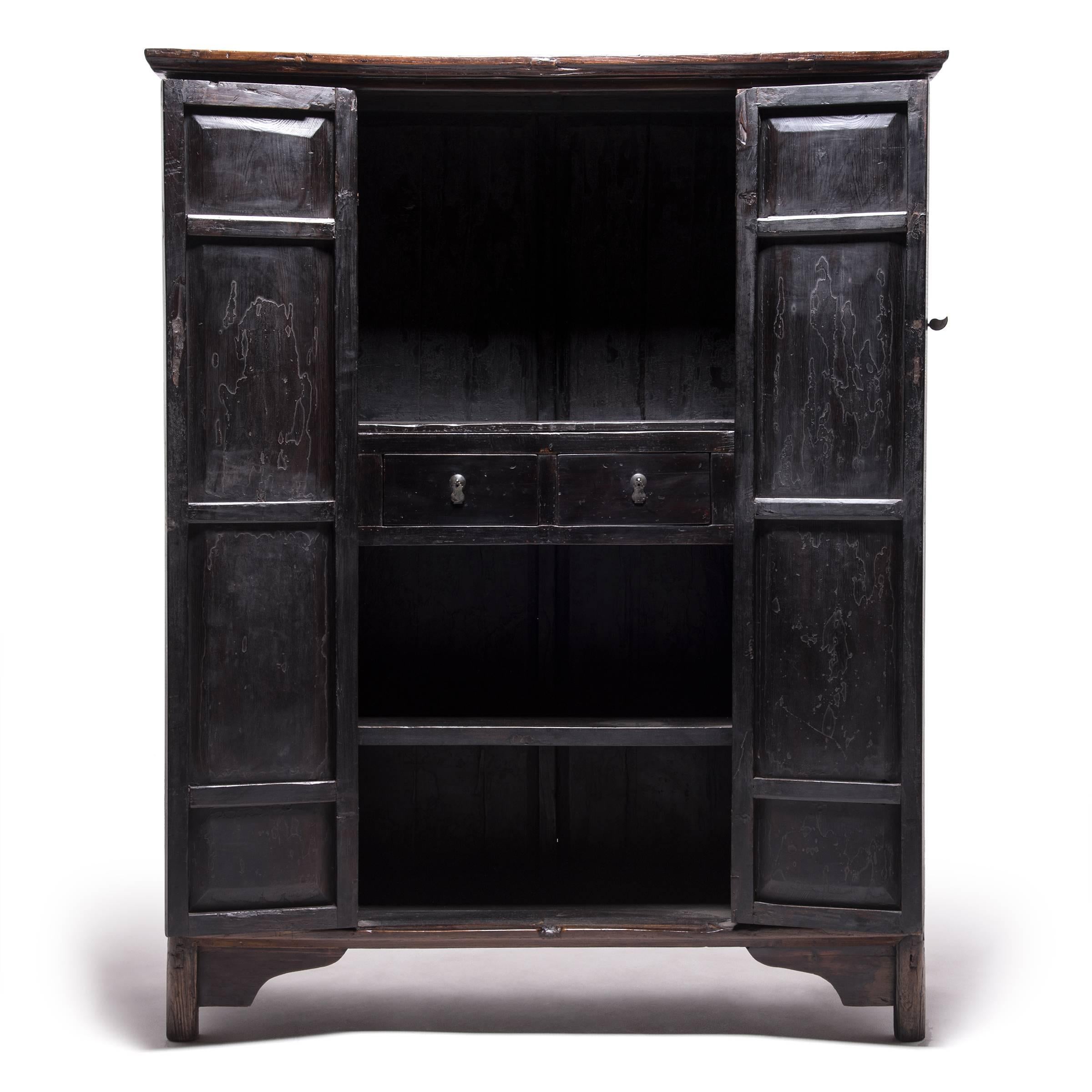 The Qing-dynasty cabinetmaker who designed this handsome two-door cabinet was a master of their craft, and elevated the joinery to a new artistic level. This monumental Chinese cabinet was constructed with mortise and tenon construction, without the