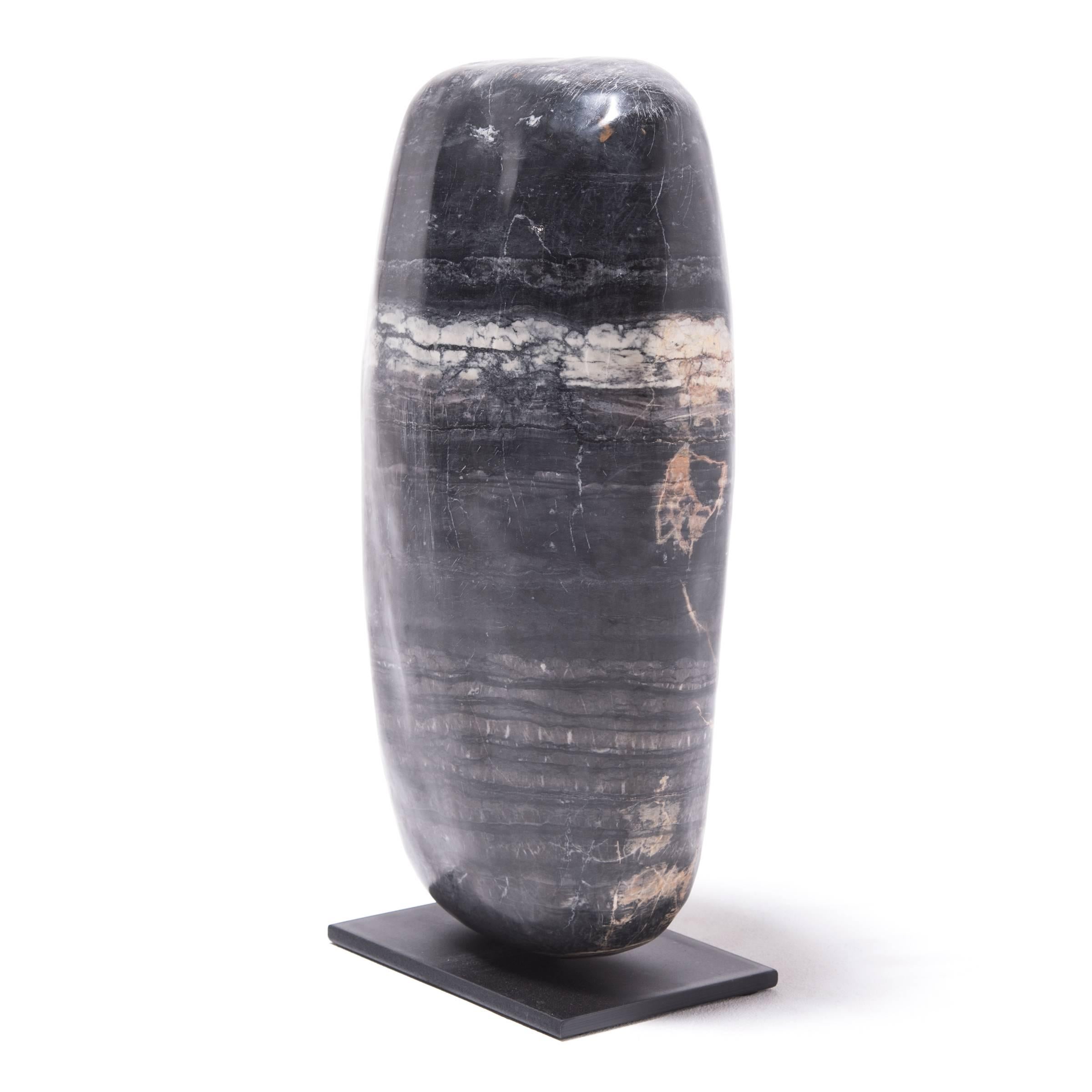 Scholar's rocks in ancient China were appreciated by artists, who collected them to inspire creativity. This stone from Shandong Province, with its natural stripes and juxtaposition of deep, dark colors and gentle tones, is thousands of years old,