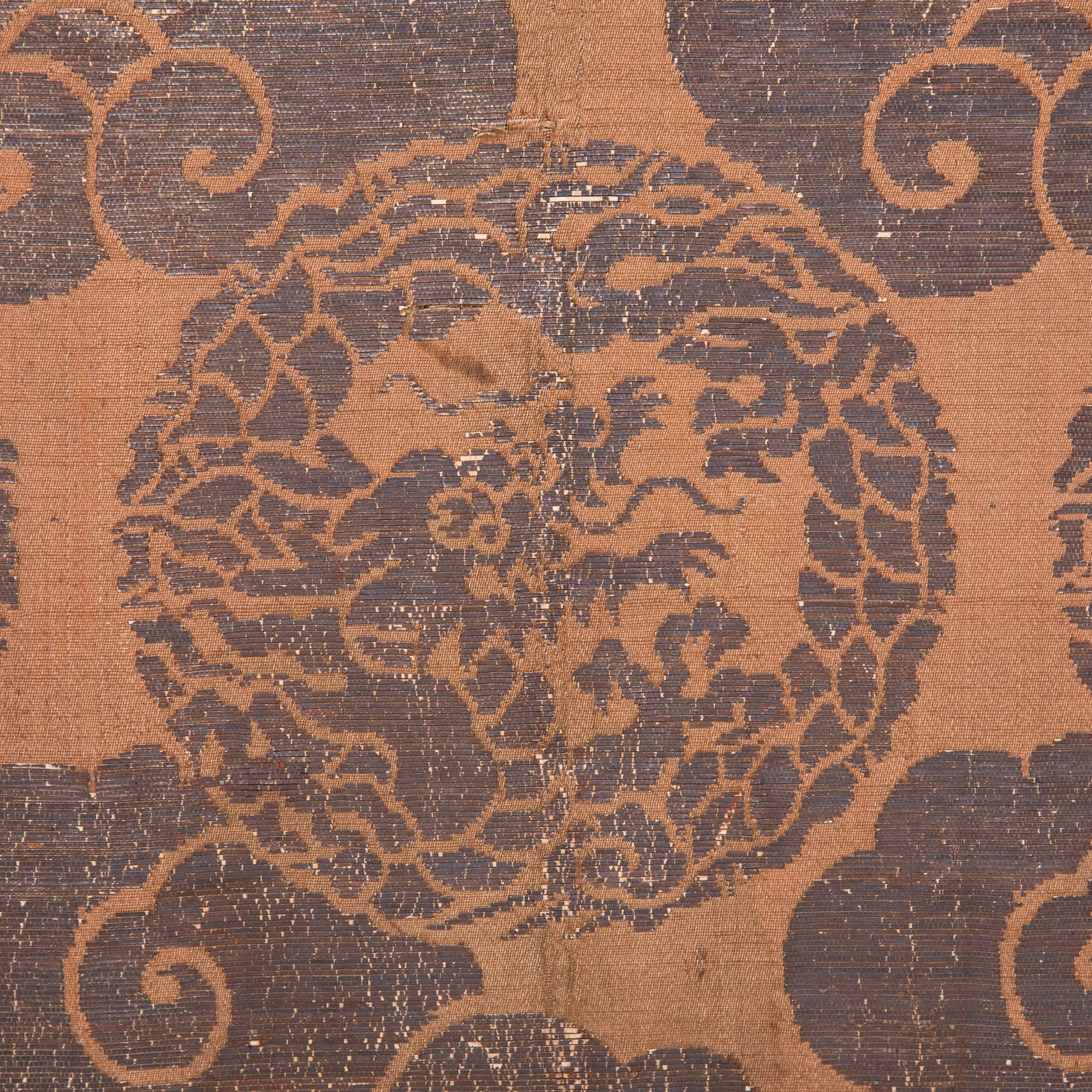 Ming dynasty textiles are extremely rare because the delicate silks and brocades wear away with time. This beautiful gold and black textile has survived the past four hundred years, and even after all this time the yellow thread is still arrestingly