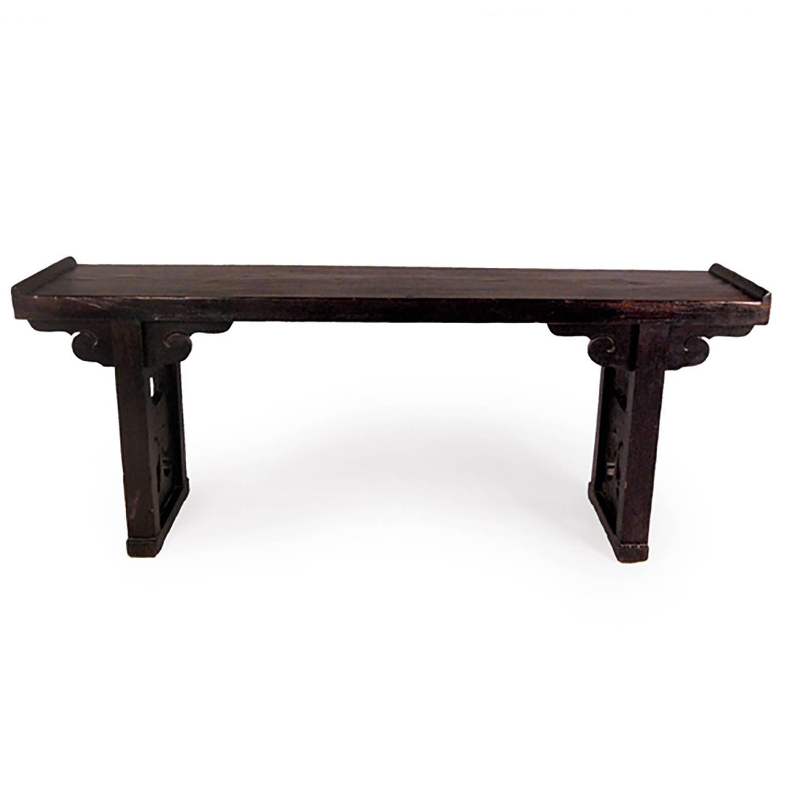 A century and a half ago this unique table may have been used as a familys altar. It was made in China’s Shanxi Province: the spandrels and leg panels are carved to look like ruyi, and the top is made from a solid piece of elmwood. Ruyi are a type