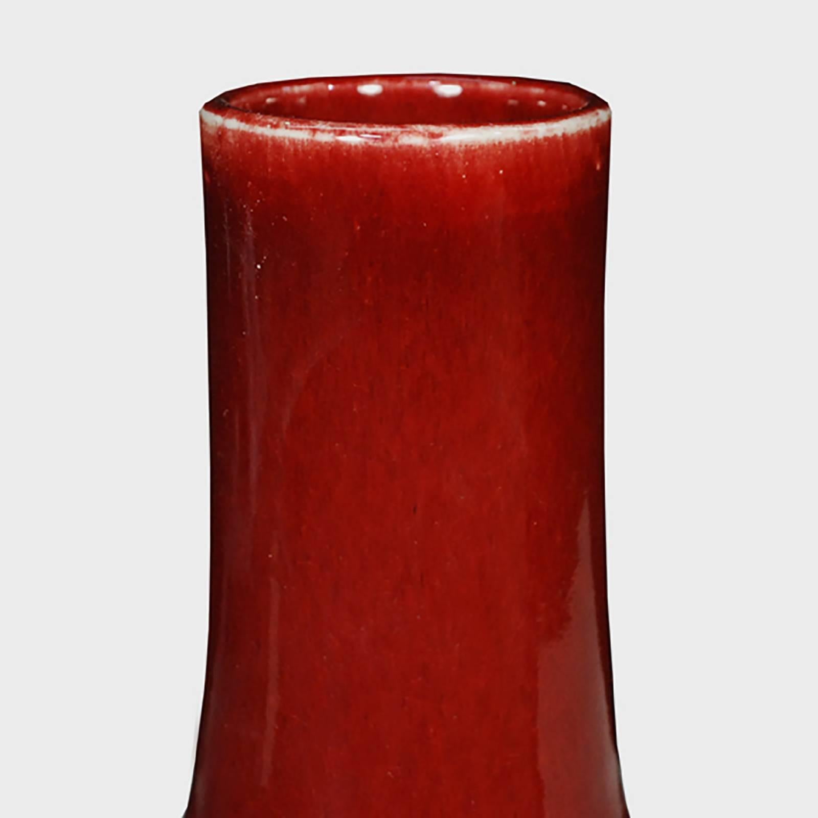 A simple and modern shape defines these bottleneck vases, known as such because of their shorter necks. The vases' deep, rich red glaze is often called 
