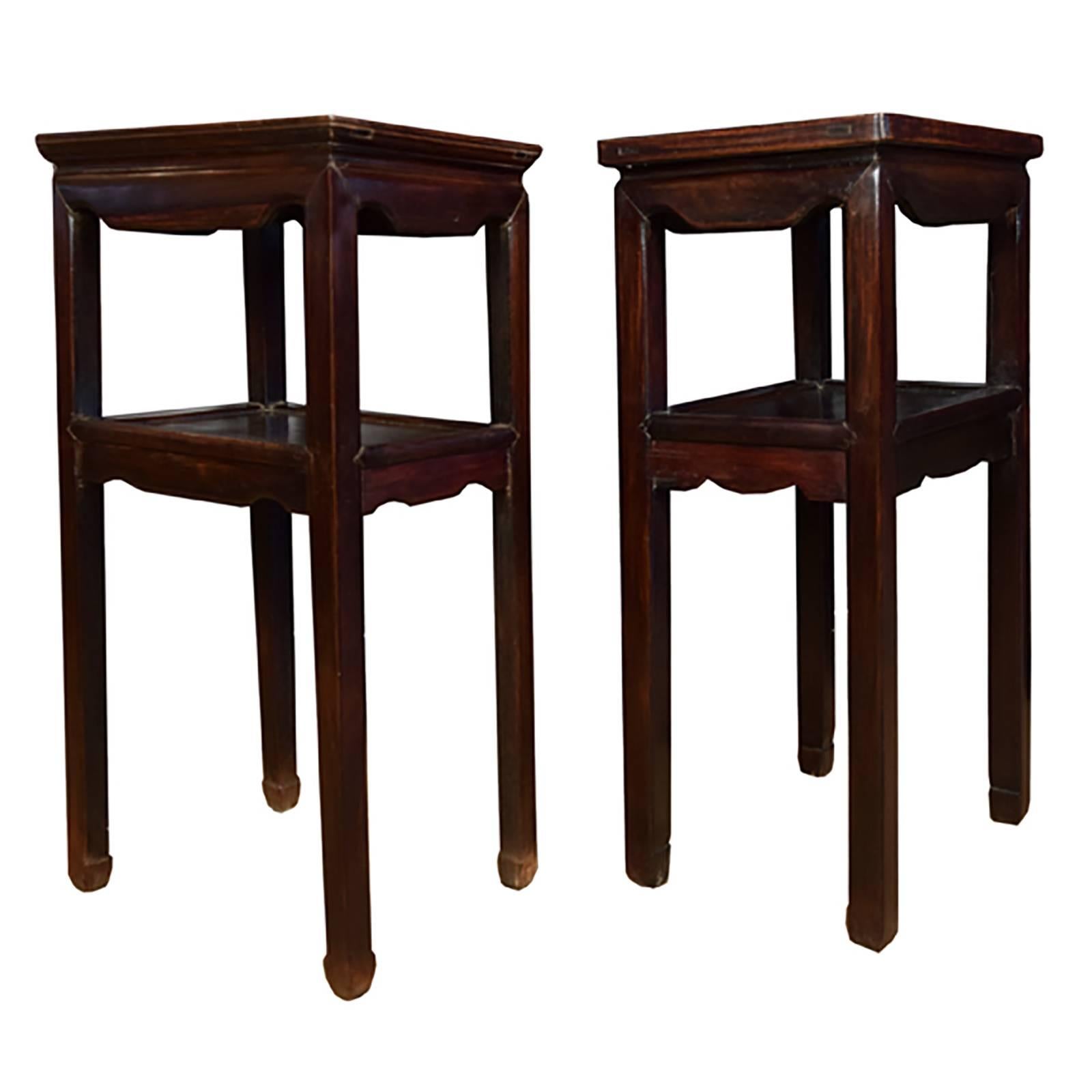 Crafted with mortise and tenon joinery, this skillfully constructed pair of tea tables is minimally detailed with just the suggestion of hoof feet and carved apron to put the full attention on the natural beauty of rosewood. Exhibiting a rich hue,