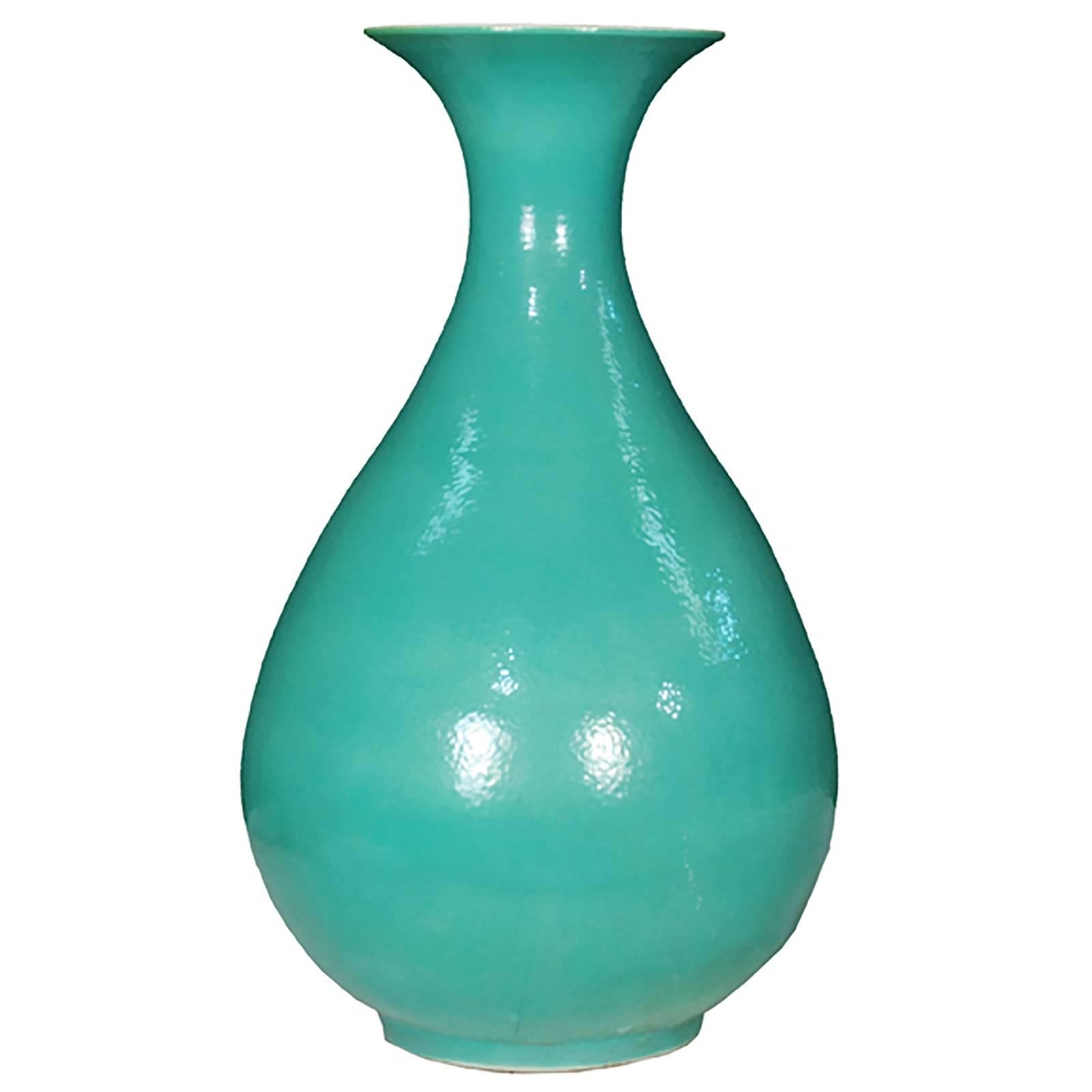 The striking monochrome of this vase draws on a long Chinese tradition of ceramics glazed in a single, statement-making color. In the 19th century, Chinese artisans revived the art of blue and green glazes resulting in this rich turquoise. The