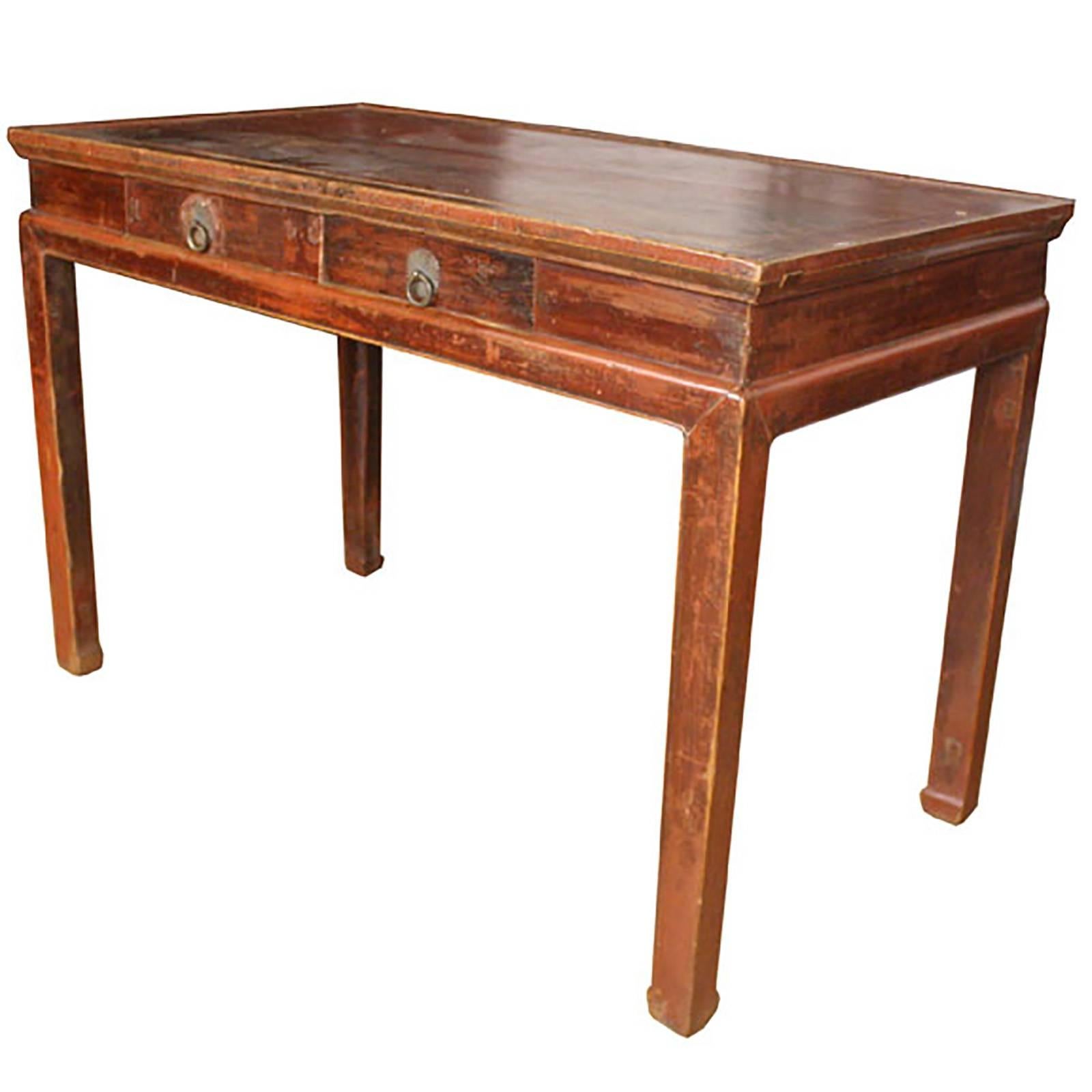 With its open tabletop and roomy leg space, this table is the perfect space for your laptop, writing letters or greeting visitors in the foyer. The original lacquer has weathered to a warm russet tone. The solid Qing dynasty craftsmanship and