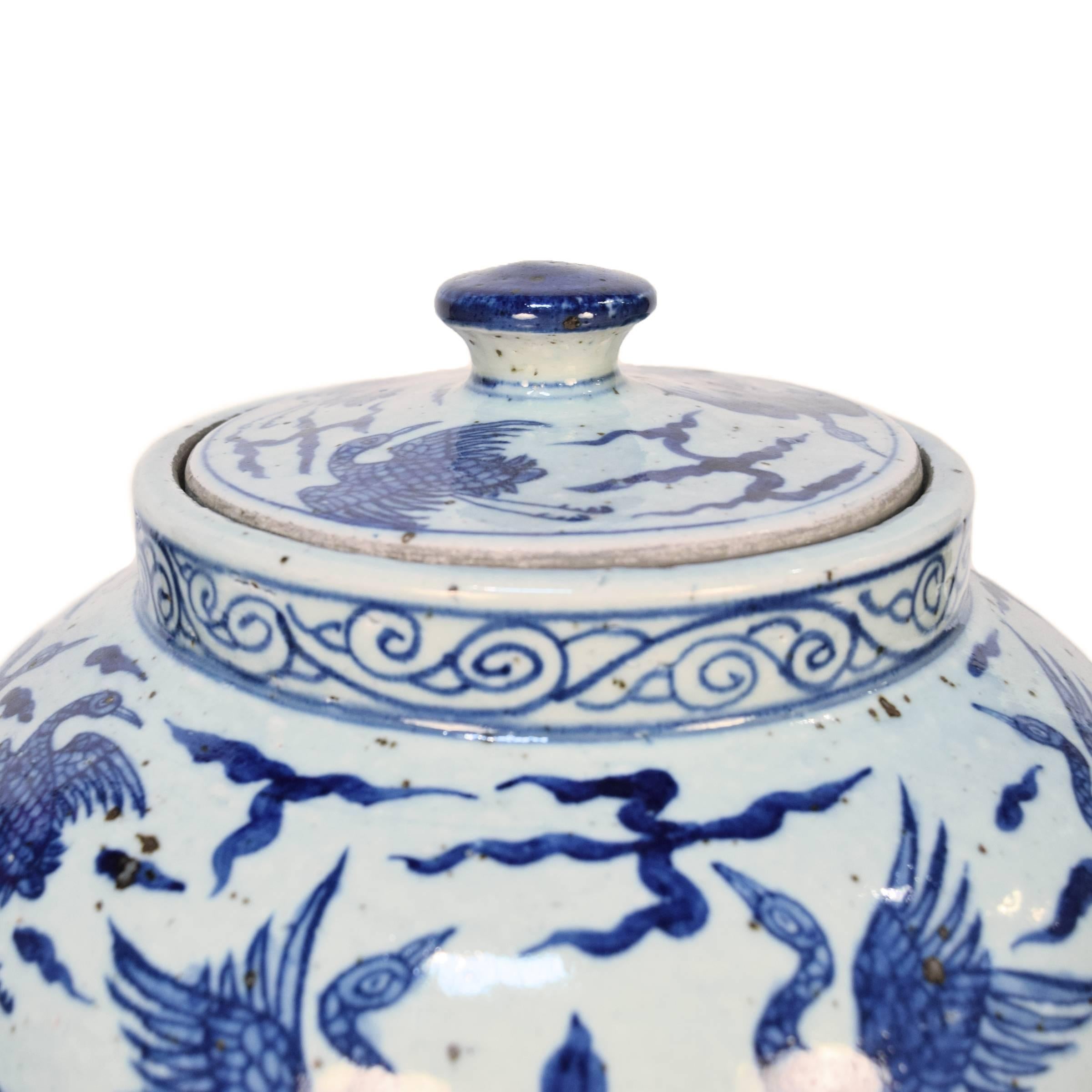 This elegant porcelain vase dates from the 19th century when such pieces became widely popular in China, the vase has a traditional blue and white floral design painted with intricate detail by a skilled artisan. Blue-and-white porcelain originated