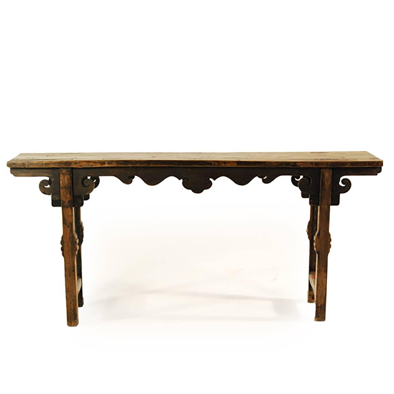 The artisan who carved this Provincial table out of pine added personal touches: highly carved apron, legs, and spandrels in the form of lingzi (auspicious mushroom). It was made over 150 years ago in the Gansu region of China. Long, narrow tables,