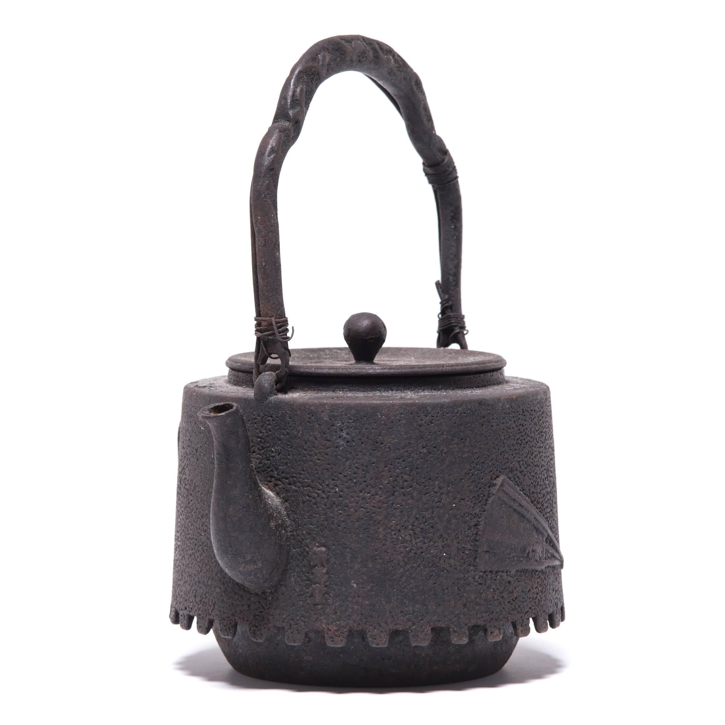 Decorated with a raised fan motif, this aptly named teapot was used to boil water for traditional tea ceremonies. The kettle’s cast-iron construction is said to change the quality of the water, making tea taste mellow and sweet. Made by pouring iron