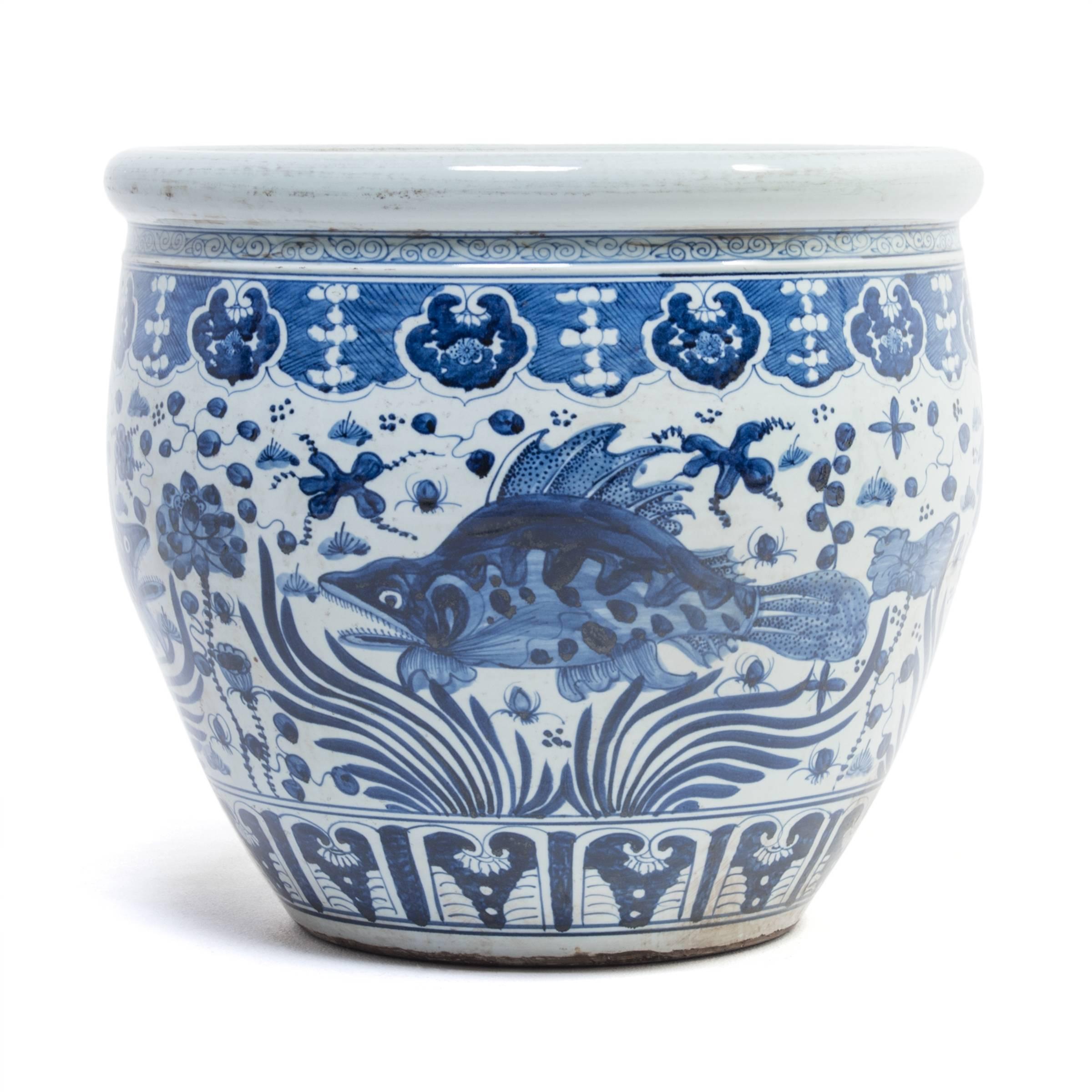 This grand scale, blue and white porcelain bowl is painted by hand with fish and flora from the sea, representing blessings for wealth and life as content as fish in water. Chinese blue and white ceramics have inspired ceramists worldwide since
