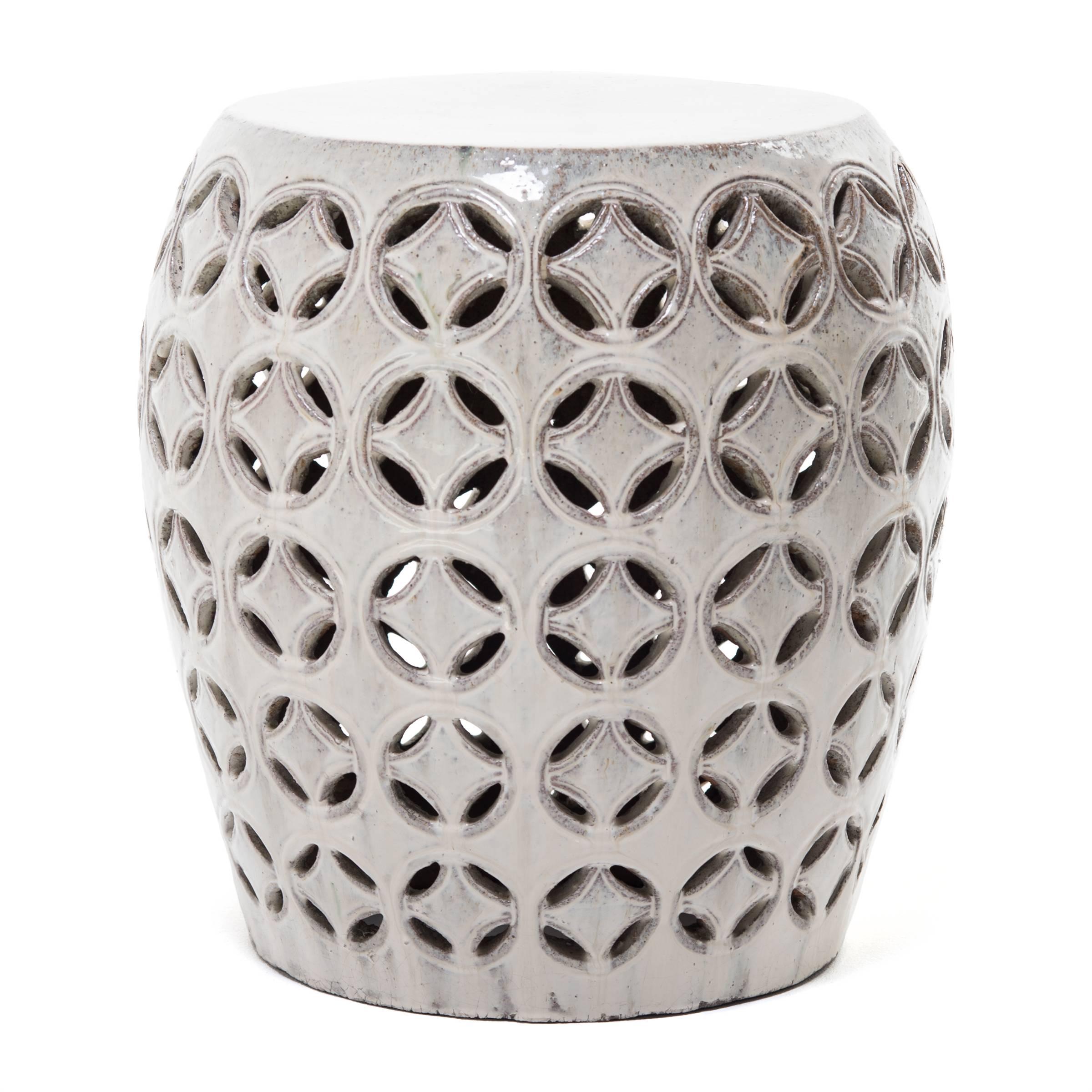 This ceramic garden stool is from China’s Jiangxi Province, and is a modern interpretation of a Classic design: the rich white glaze enhances the artistry and elegance of the form. The coin motif is an ancient symbol of good fortune. Garden stools