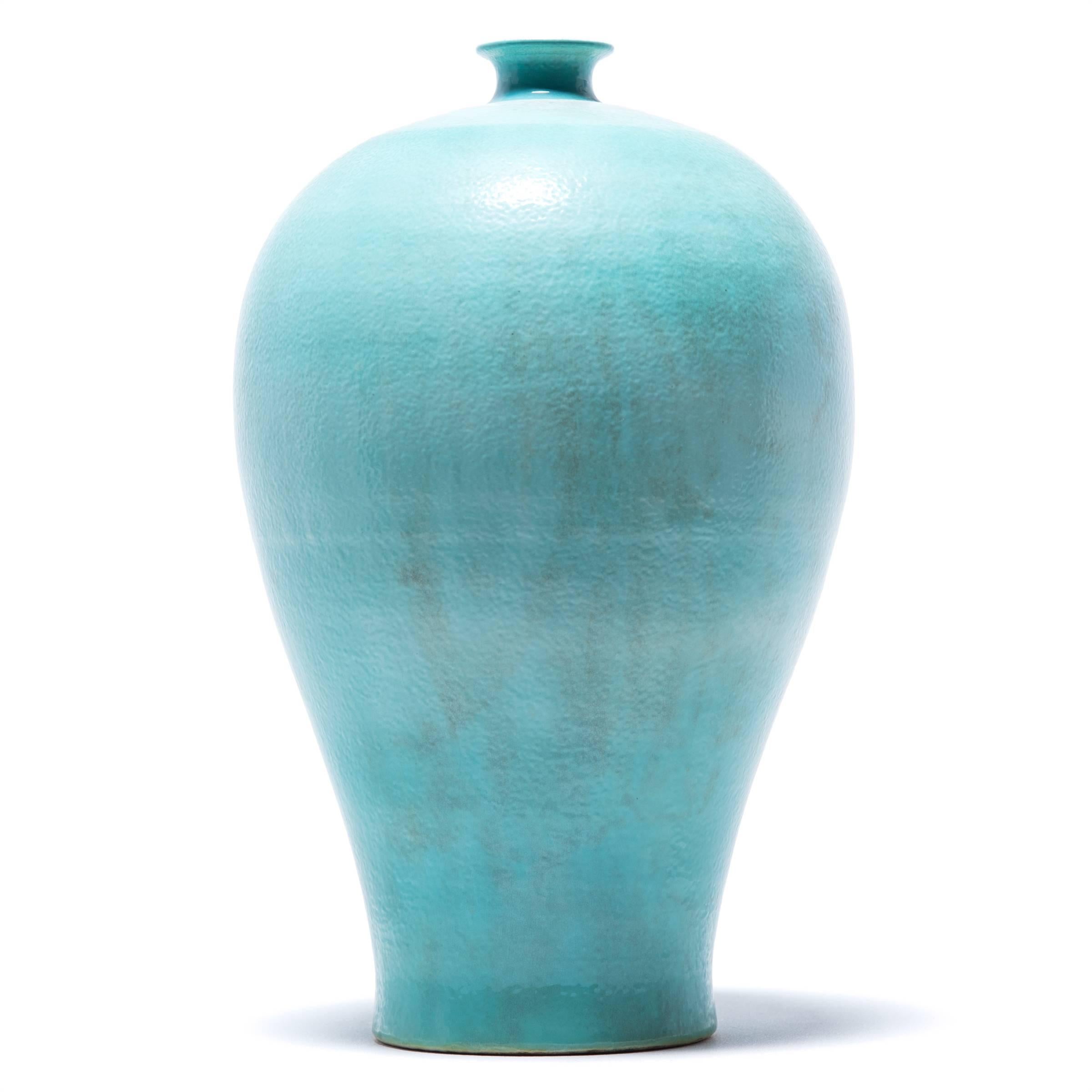 Meiping vases were traditionally used to hold the branches of plum trees, celebrated in China as symbols of strength. Glazed in arch jade color, this contemporary vase was made in Southern China using ancient techniques rooted in the Song dynasty
