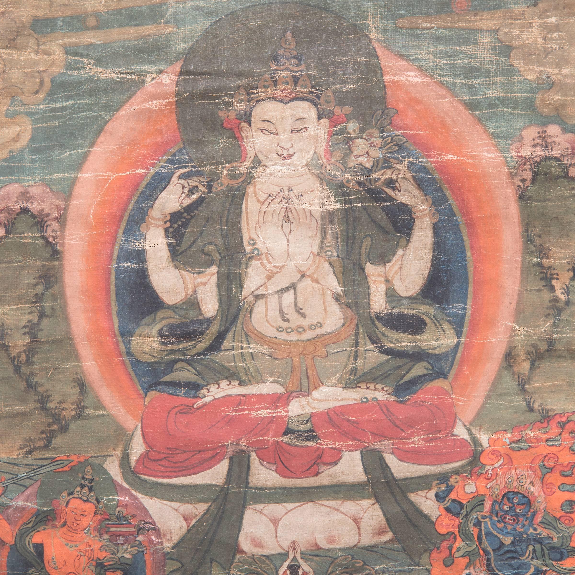 Tibetan Thangka depicting a central Buddha figure before a mandala on a lotus plinth embracing the consort, the lower register having a deity figure emerging from a white lotus flanked by two bodhisattva figures.

 