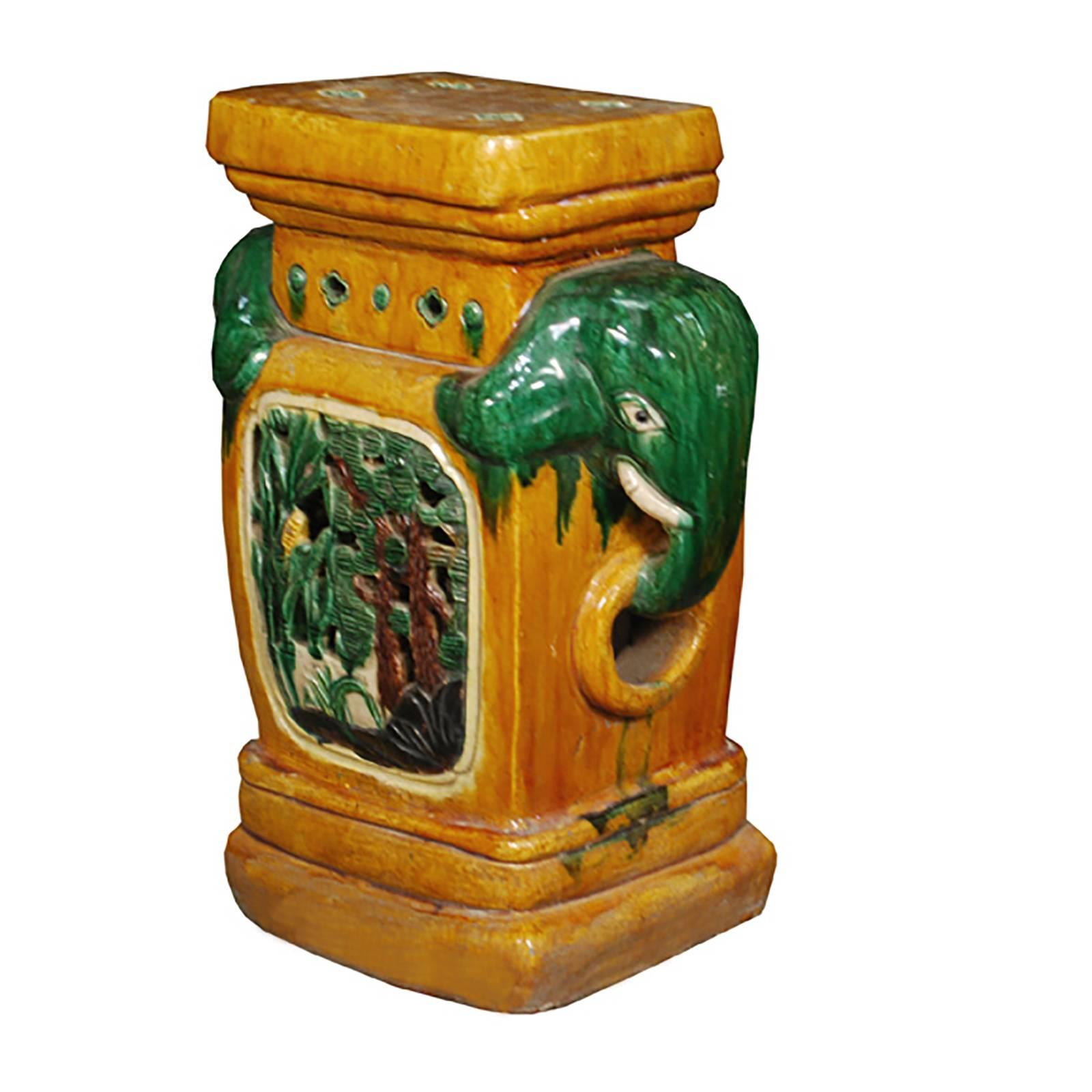 Symbols of strength and wisdom, a pair of emerald green elephants are prominent features of this lushly glazed ceramic stool. Also embellished with medallions of forest scenes and incised and colored small decorations, the stool was made around 1900