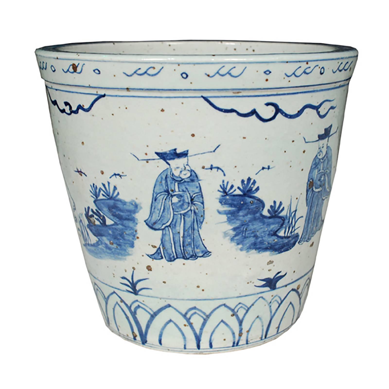 This unique pot was made by hand in southern China and is a wonderful example of blue and white ceramics that are sought worldwide by collectors. The scene wraps around the entire pot and is painted in rich blue feathery brushstrokes. The figures