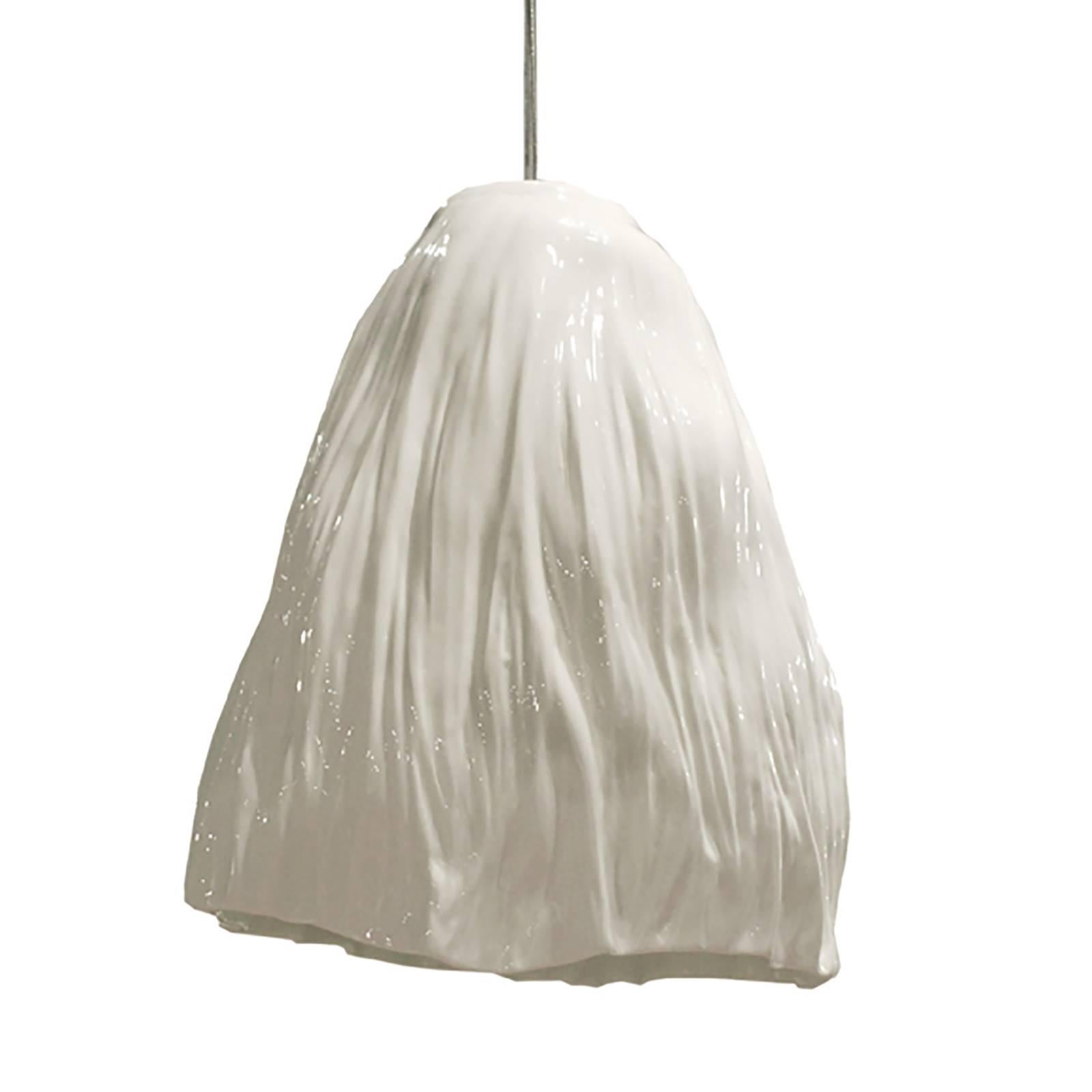 Xie Dong, a Beijing-based ceramist, works conceptually to capture moments of time in porcelain. Each SHUI pendant gracefully mimics draping fabric while maintaining the highest level of craftsmanship. The art of creating pure white porcelain, thin