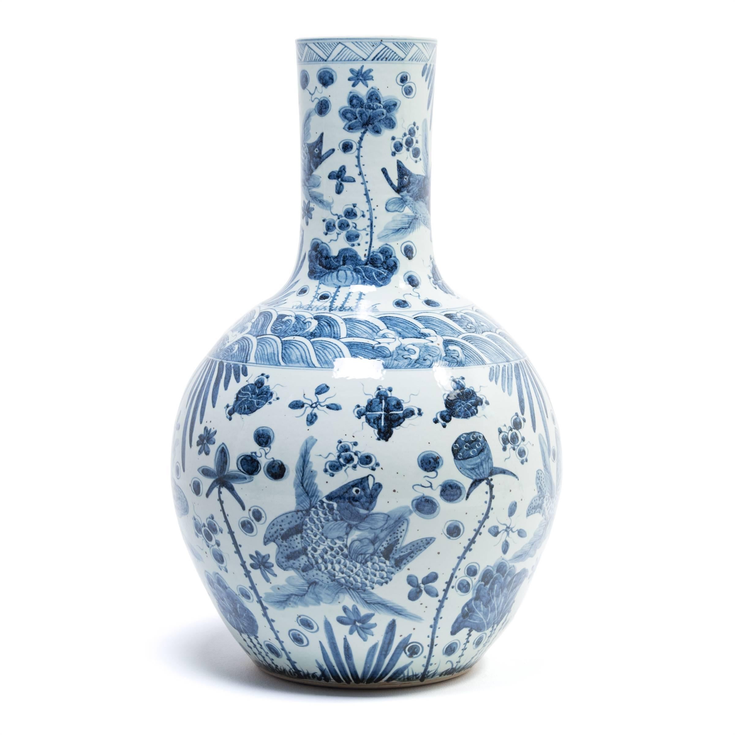 Revered for centuries for its elegant designs and rich cobalt blue and pure white colors, traditional Chinese blue-and-white porcelain lives on in this hand-painted bottleneck vase. Delicately rendered with koi amidst fanciful waves, the vase's
