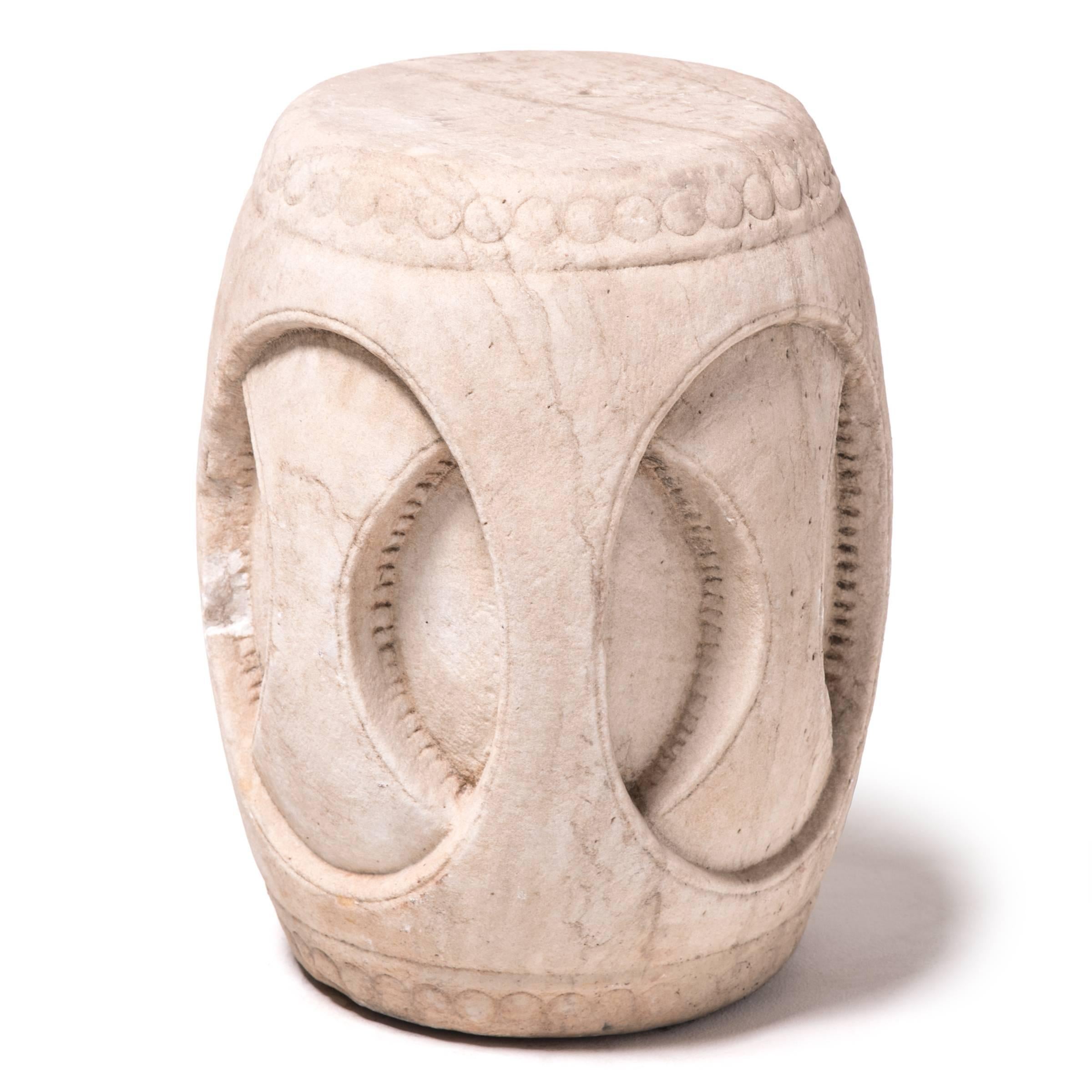 Barrel-shaped stools have been fixtures in traditional Chinese gardens since the Song dynasty. Originally made from hardwood, stools were later crafted from ceramic or stone. This intricately carved version features an incised pattern that plays