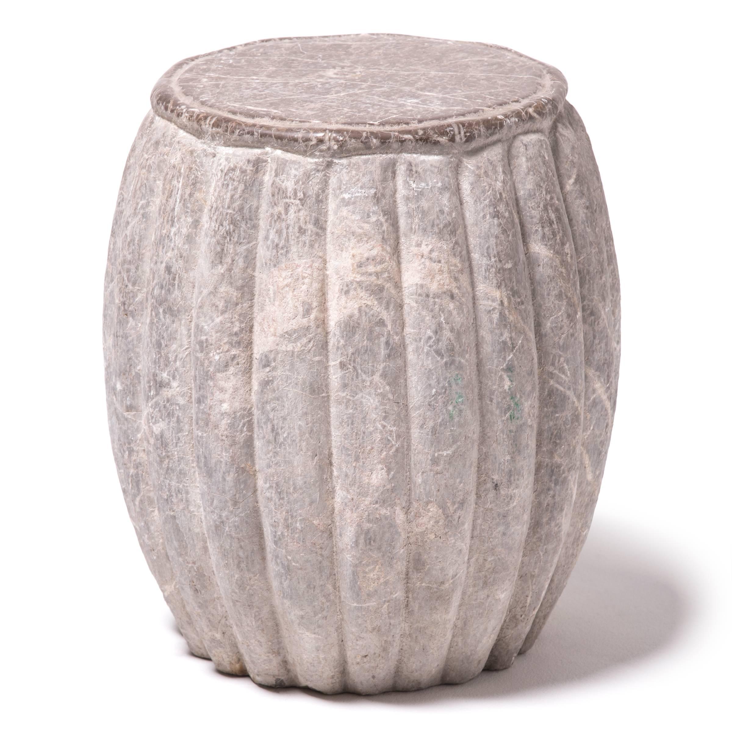 Marked by expressive veining, this handsome table was carved in China’s Shanxi province out of a piece of solid limestone. Ribbed and rounded, the form suggests a melon, an ancient Chinese symbol of perpetuity. Traditionally used in a garden as a